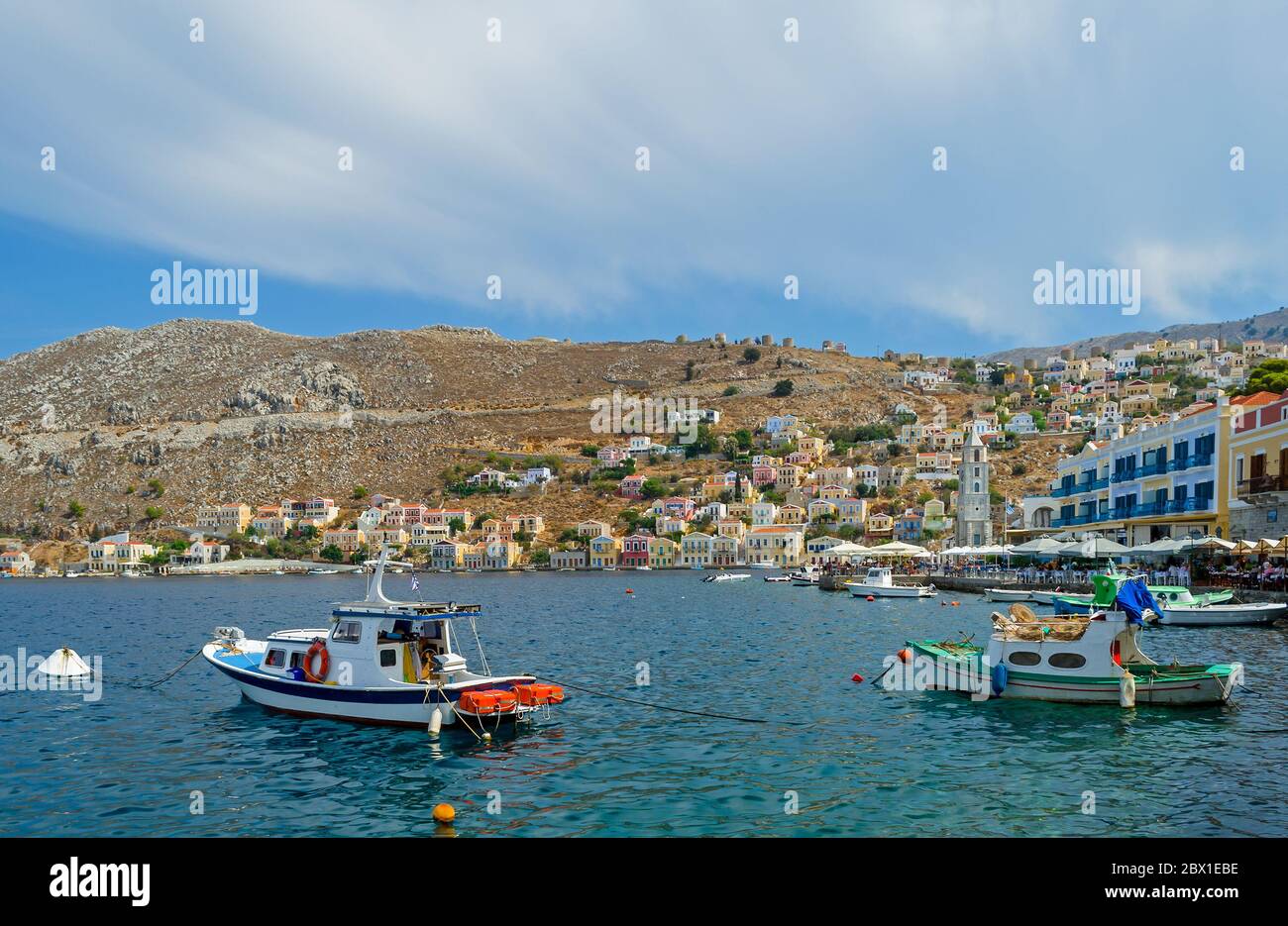 Symi Hafen mit neoklassizistischen Gebäuden und Fischerbooten Stockfoto