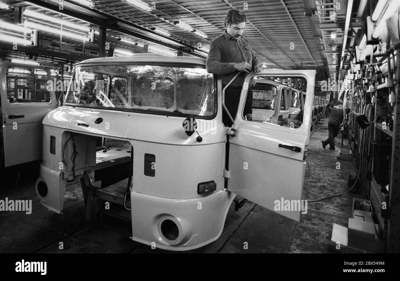 Brandenburg / DDR / 4 / 1990 IFA LKW-Werk in Ludwigsfelde, Arbeiter am Fließband. Stationäre Lkw im Ostblock // Fahrzeugbau / Arbeit / Industrie / [automatisierte Übersetzung] Stockfoto