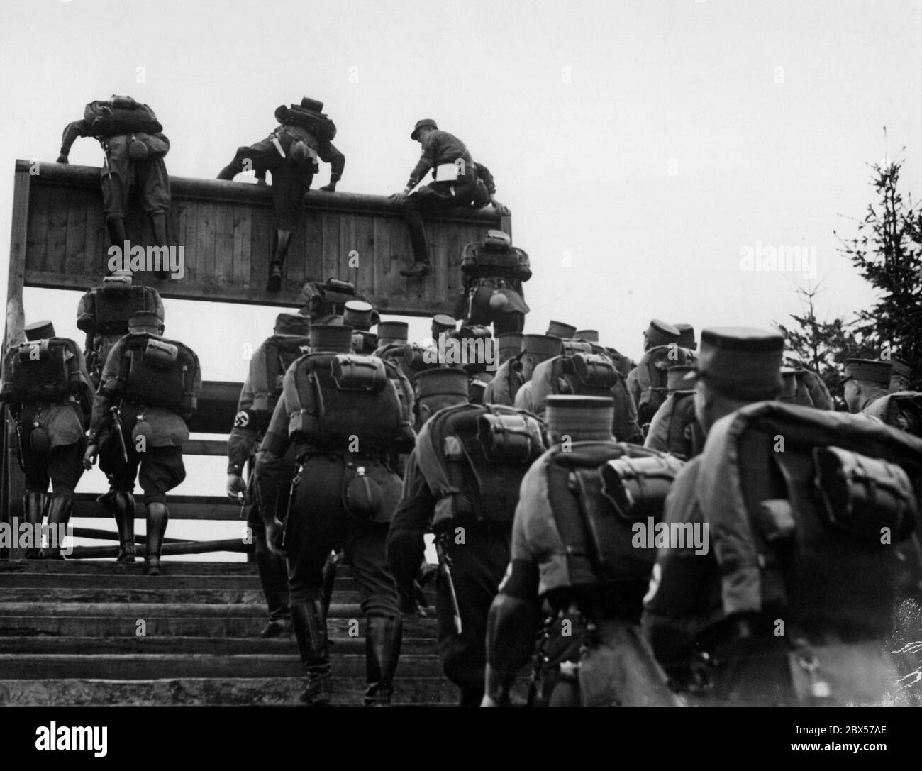 SA-Männer überwinden eine Hindernismauer, während des 25 Kilometer langen rudelmarsches bei den NS-Kampfspielen. Stockfoto