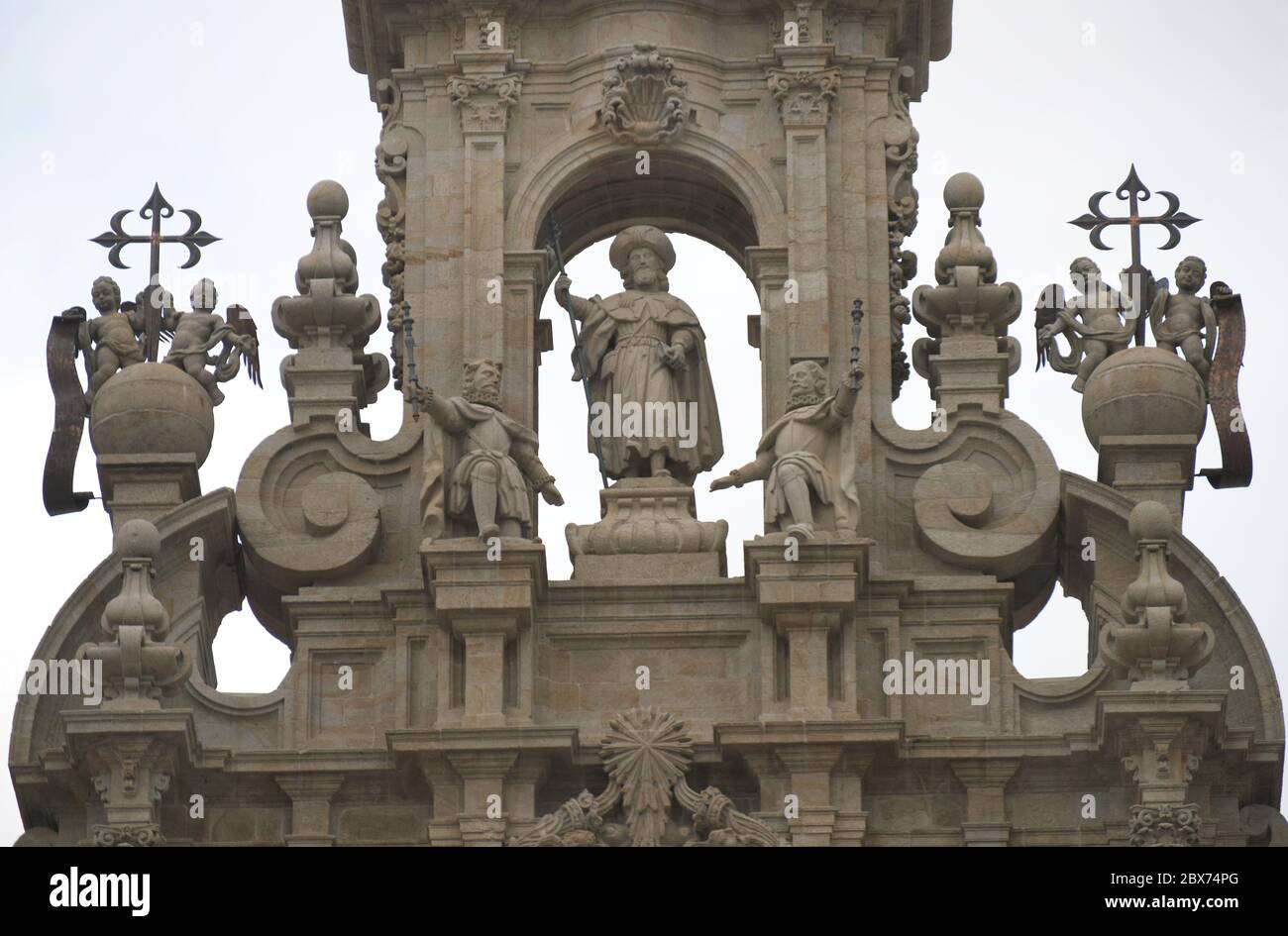 Spanien. Kathedrale von Santiago de Compostela. Architektonische Details des oberen Teils. Statue des Heiligen Jacques Pilgrim flankiert von Engeln mit den Kreuzen von Santiago (18. Jahrhundert). Santiago de Compostela. La Coruña Provinz, Galicien. Stockfoto