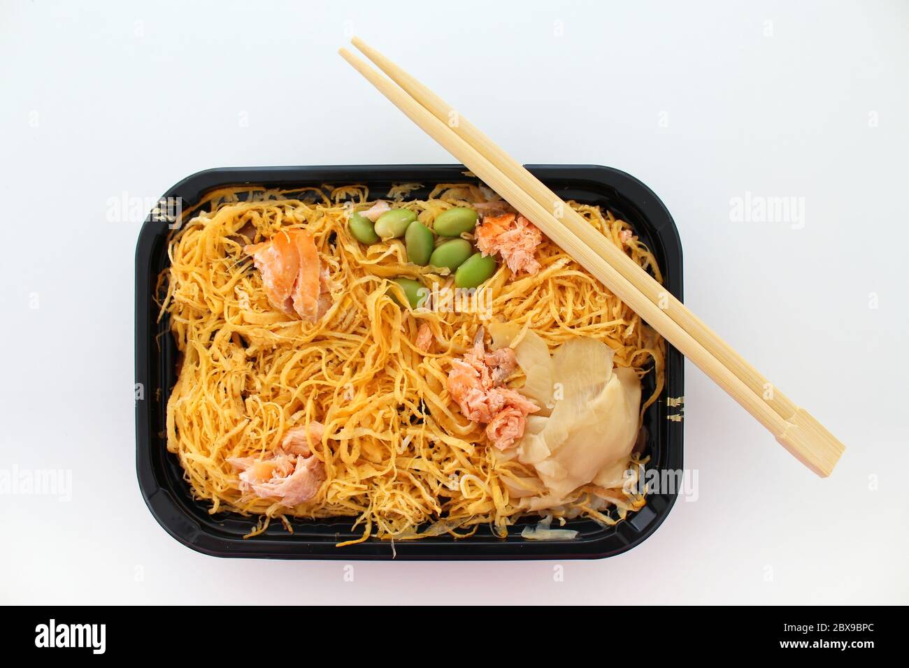 „Chirashi Sushi“, auch bekannt als „StreuSushi“, ein traditionelles japanisches Gericht aus Fischstücken (hier: Lachs) mit Sojabohnen, Eieromelett, Ingwer. Stockfoto