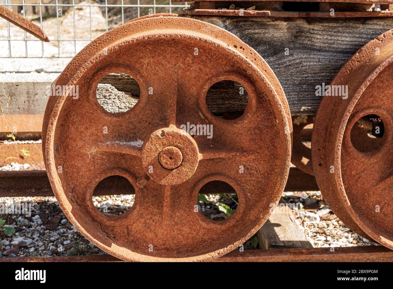 Nahaufnahme von rostigen Rädern eines alten Bergwerkwagens auf den Schienen. Friaul Julisch Venetien, Italien, Europa Stockfoto