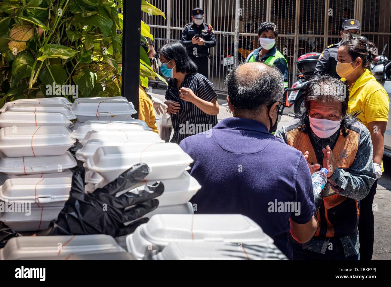 Freiwillige geben während der Covid-Pandemie in Bangkok, Thailand, an arme Menschen in der Küche kostenloses Essen aus Stockfoto