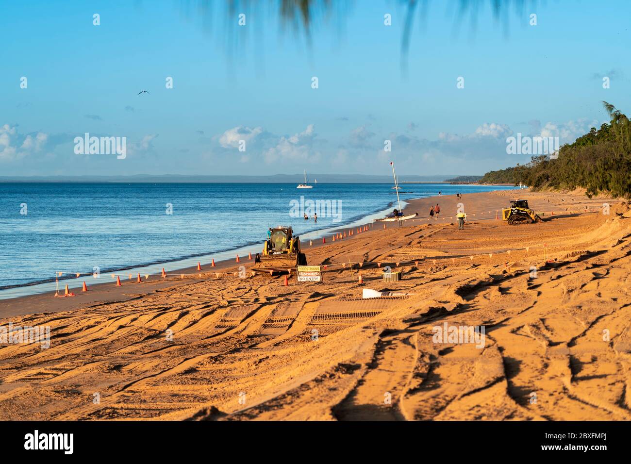 Maschinen, die Strandrestaurierung und Erosionskontrolle durchführen. Scarness Beach Hervey Bay Stockfoto