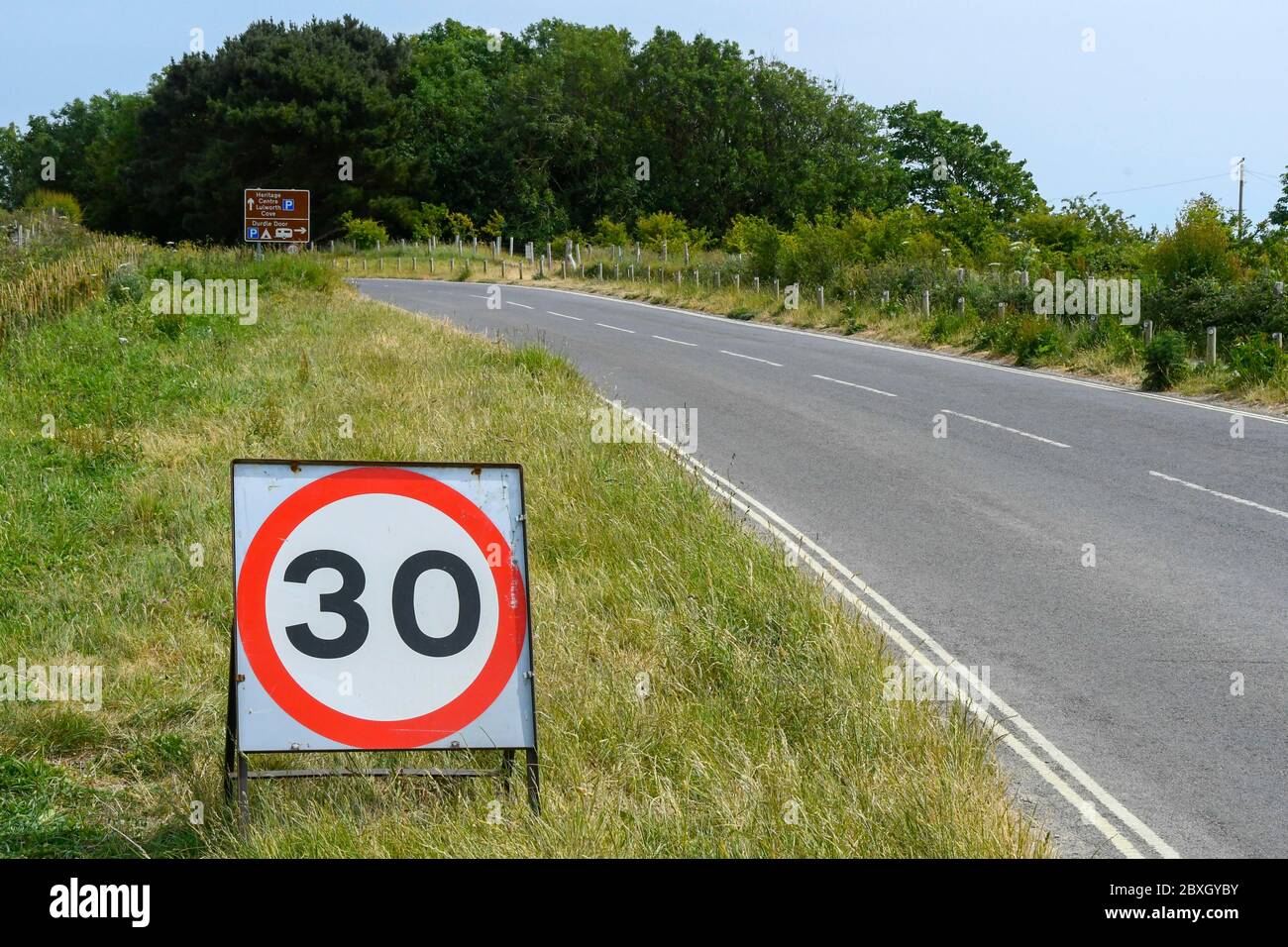 Durdle Door, Lulworth, Dorset, Großbritannien. Juni 2020. Wetter in Großbritannien. Die Besucherzahlen sind stark reduziert als am Wochenende zuvor im Durdle Door in Lulworth in Dorset aufgrund der niedrigeren Temperaturen und der trüben Sonne. Der Weg zum Eingang zum Parkplatz mit einer vorübergehenden Geschwindigkeitsbegrenzung von 30 km/h voraus, da diese Woche neue Beschränkungen in Kraft treten, um die Besucherzahlen zu kontrollieren. Bild: Graham Hunt/Alamy Live News Stockfoto