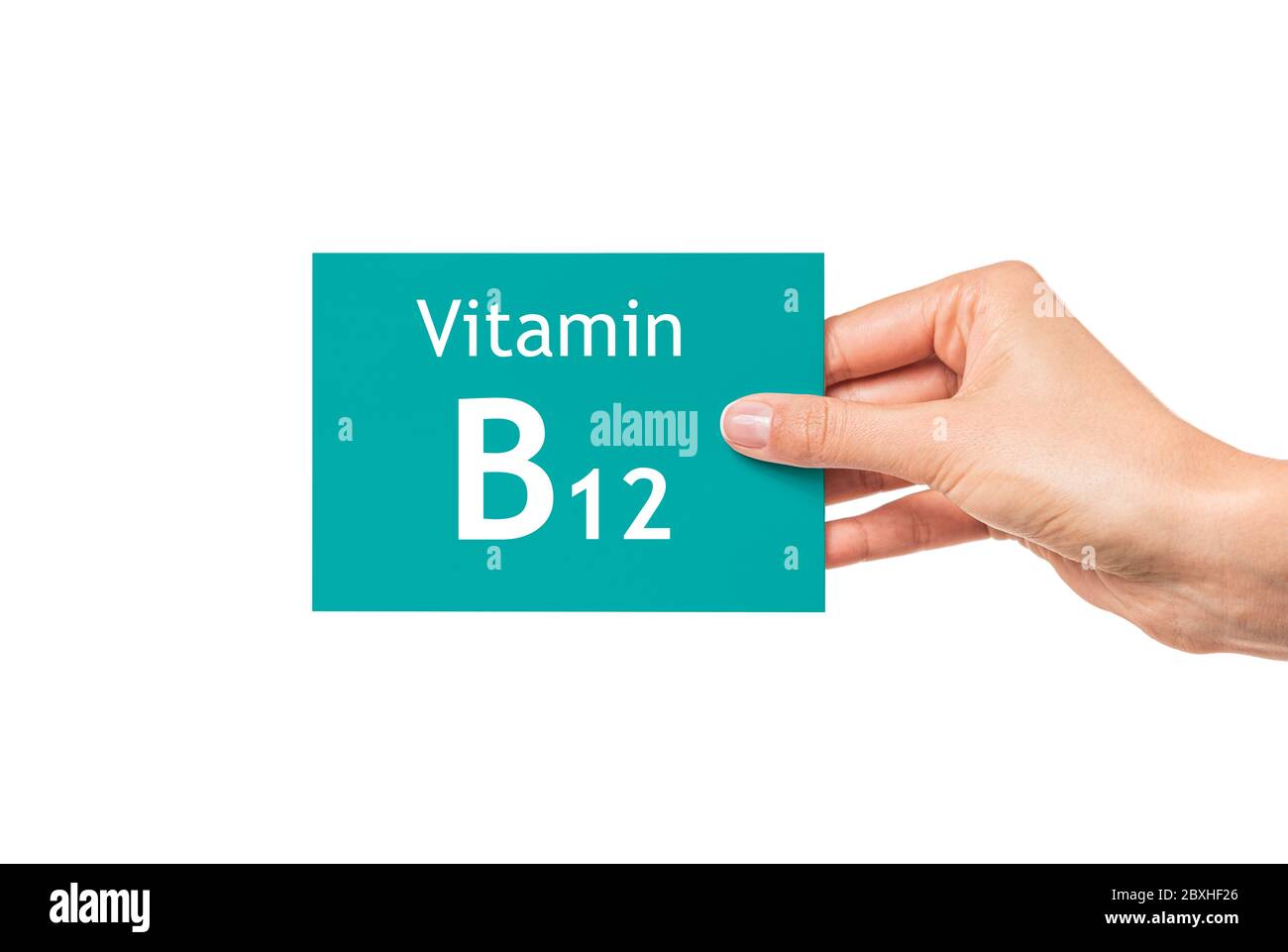 Weibliche Hand zeigt eine Karte mit der Aufschrift Vitamin B12. Vitamin B12. Stockfoto