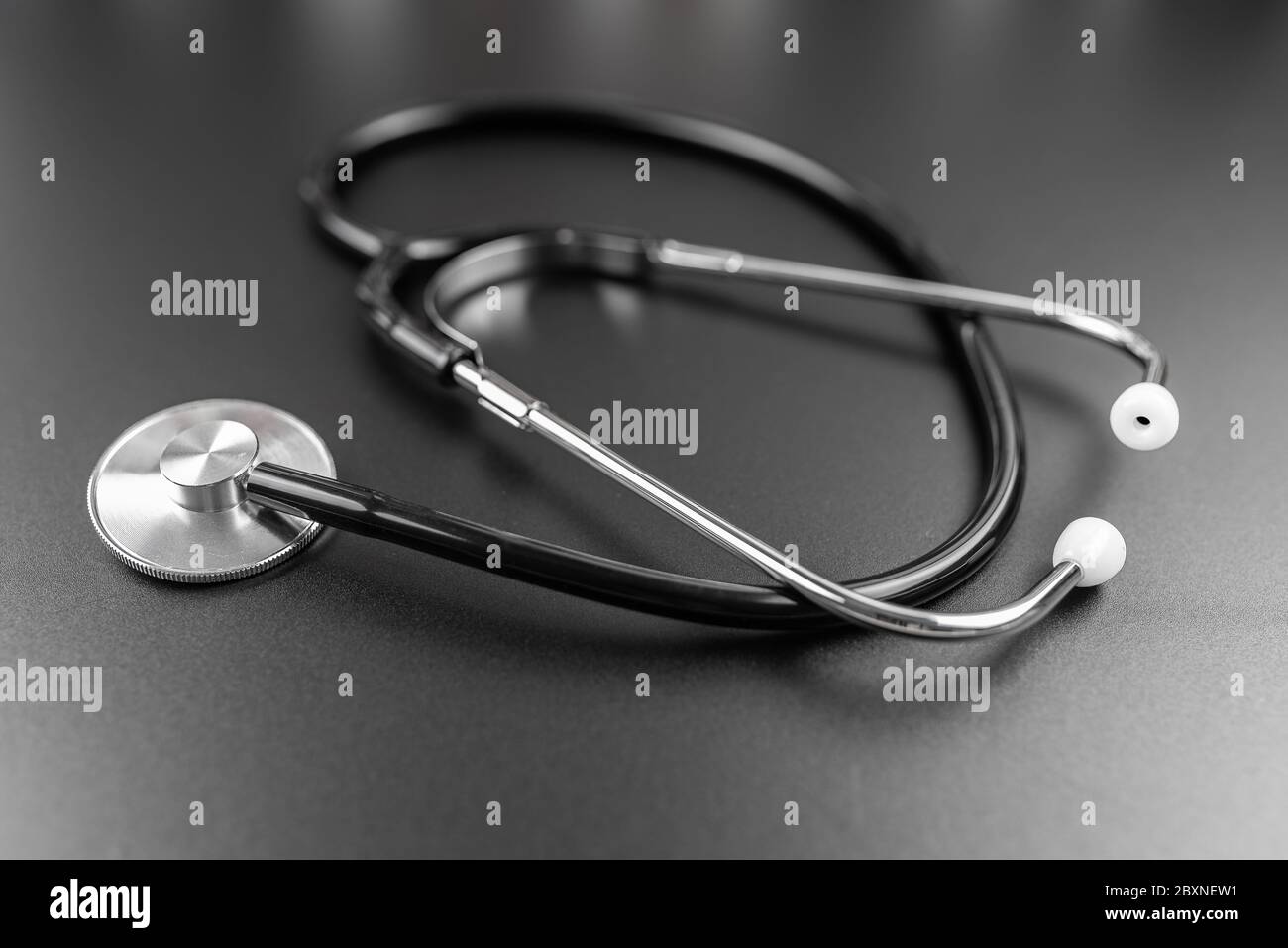 Nahaufnahme des Stethoskops auf dunklem Tischhintergrund, medizinische Untersuchung und Diagnosekonzept Stockfoto