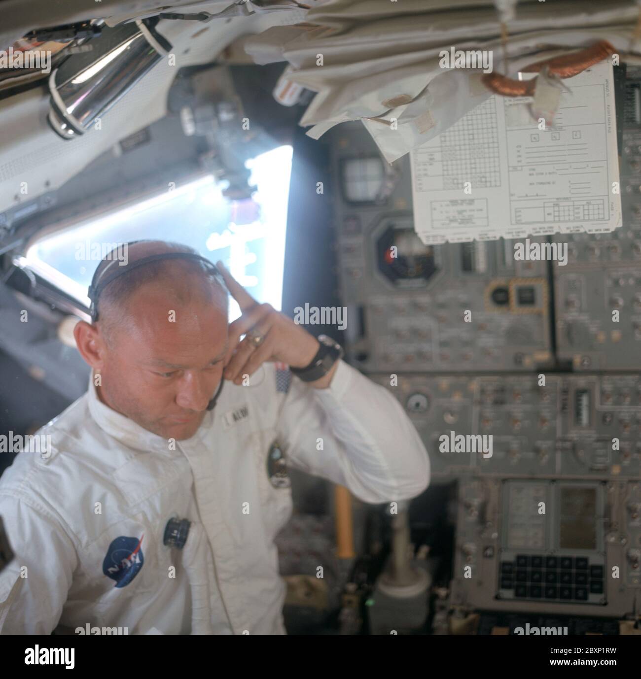 AS11-36-5391 - Apollo 11 - Apollo 11 Missionsbild - Astronaut Edwin E. Aldrin im Mondlandemodul; Umfang und Inhalt: Die Originaldatenbank beschreibt dies als: Beschreibung: Astronaut Edwin E. Aldrin Jr., Pilot des Lunar Module, passt sein Kommunikationskopfhörer während der Kasse und Inspektion nach der Luke an, während er im Inneren des Lunar Module (LM) arbeitet. Aufnahme während der Translunierphase der Apollo 11 Mission von Astronaut Neil A. Armstrong, Kommandant der Apollo 11 Mission. Original Filmmagazin wurde mit N beschriftet; Filmtyp: S0-368 Farbe; 80mm Objektiv. Betreff: Apollo 11 Flug, Spacecr Stockfoto