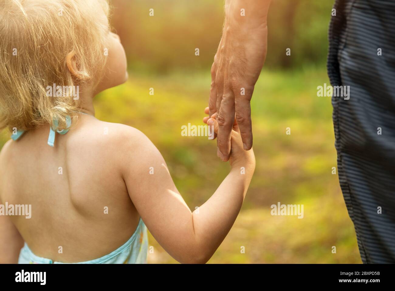 Vater und Tochter Bindung und Beziehung Konzept - Kind hält Eltern Hand Stockfoto