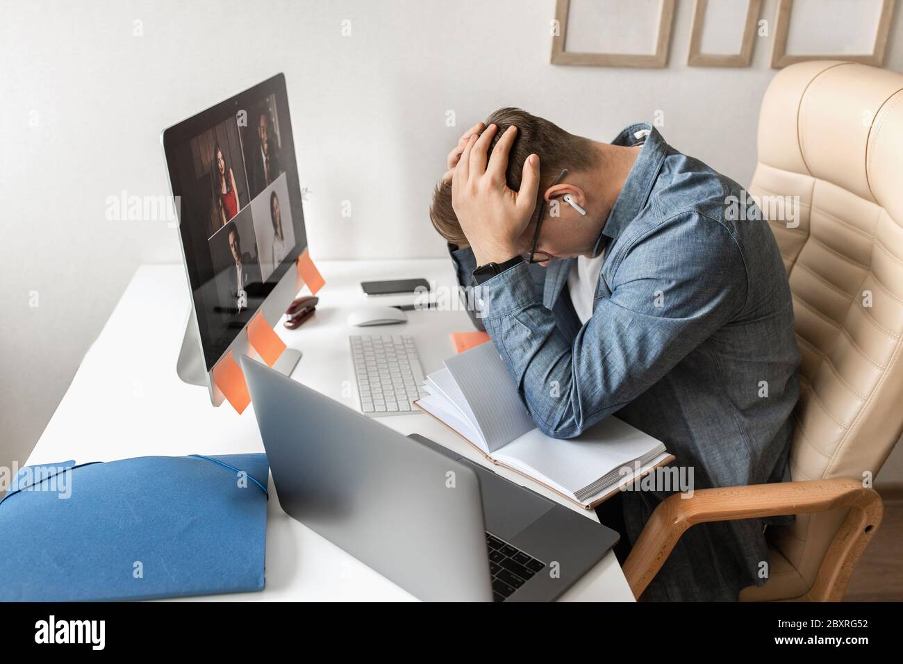 Geschäftsteam, das von zu Hause aus in einer Videokonferenz arbeitet. Mann müde von der Arbeit. Stockfoto