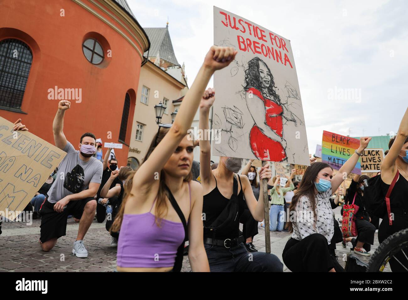 Krakau, Kleinpolen, Polen. Juni 2020. Die Demonstranten schlagen ein Knie und halten ihre Fäuste hoch, während man während des Black Lives Matter-Protests eine Zeichnung einer afroamerikanischen Frau und einen Slogan "Justice for Breonna" zeigt.Hunderte von Jugendlichen nahmen an "Black Lives Matter"-Protesten in Krakau, der größten Stadt Südpolens, Teil. Sie zollten George Floyd Tribut und drückten ihre Missbilligung der Polizeibrutalität und des Rassismus aus. Kredit: Filip Radwanski/SOPA Images/ZUMA Wire/Alamy Live News Stockfoto