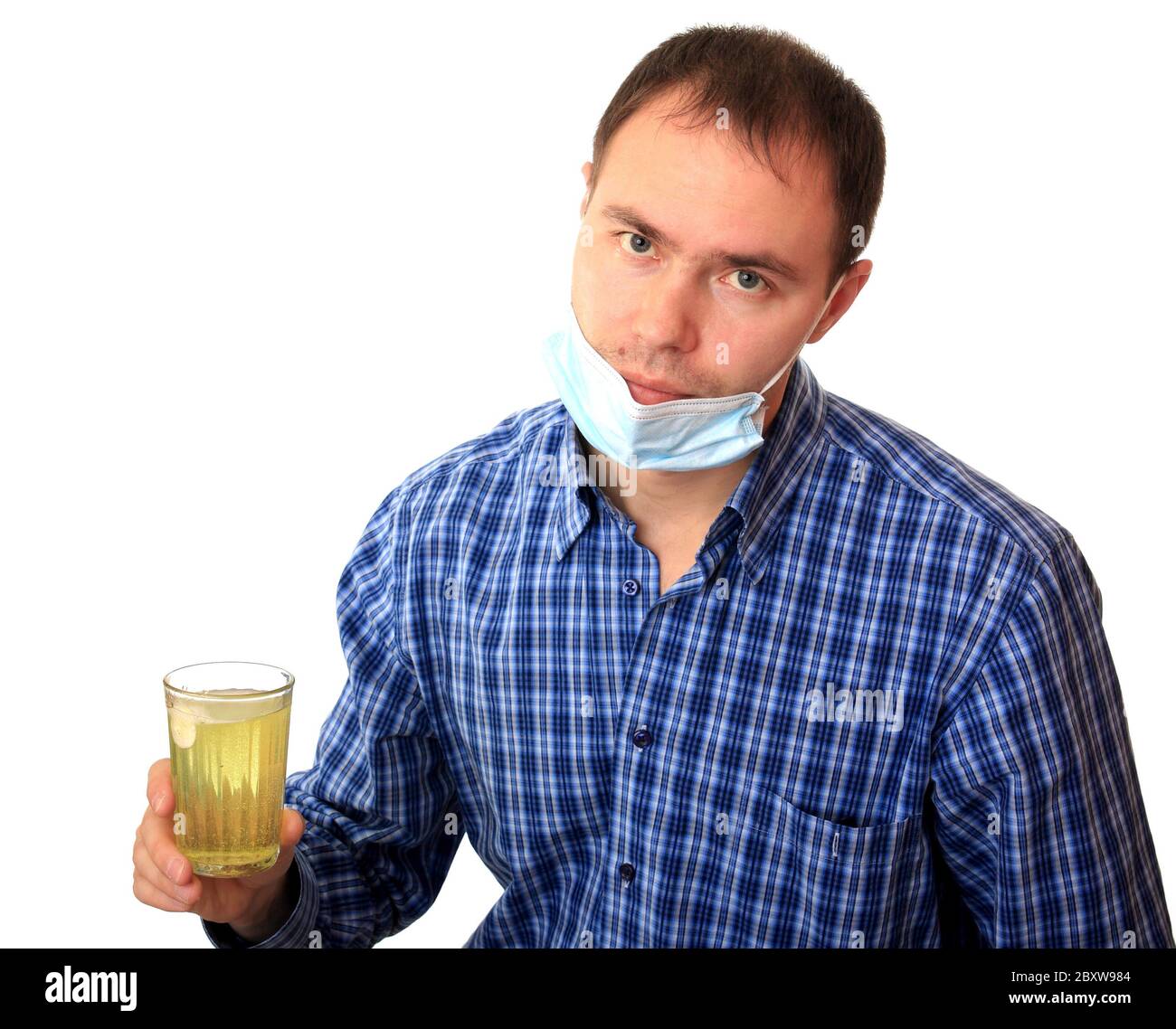 Mann in einer medizinischen Maske löst eine Pille Stockfoto