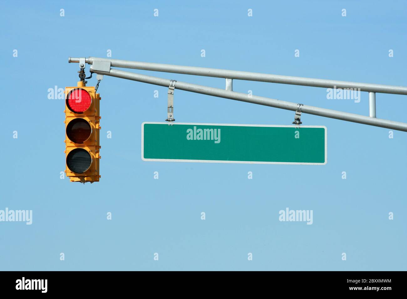 Rote Ampel mit Schild am blauen Himmel Stockfoto