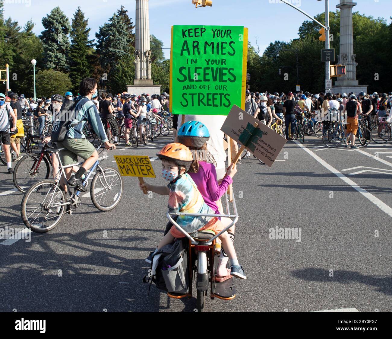 New York, New York, USA. Juni 2020. Ein Vater fährt mit seinen beiden Kindern auf dem Fahrrad, die auf der Rückseite mit Black Lives Matter-Postern gesattelt sind, bei der Grand Army Plaza 'Ride Your Bike'-Kundgebung in Solidarität mit Black Lives Matter in Brooklyn, New York. Tausende von Radfahrern nahmen an der Fahrt Teil.das schlängelte sich durch Brooklyn Credit: Brian Branch Price/ZUMA Wire/Alamy Live News Stockfoto