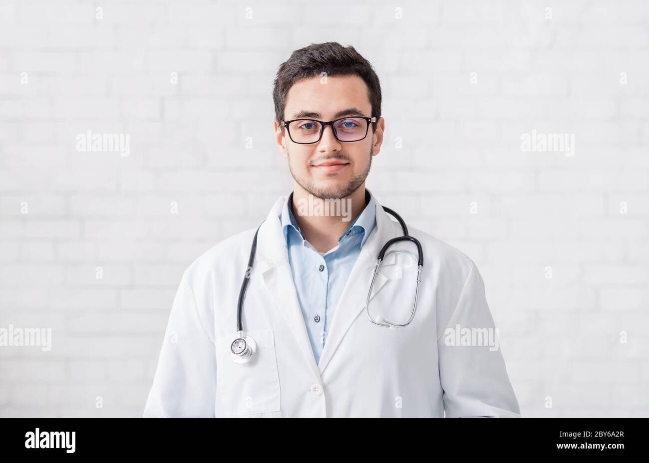 Online-Hilfe und moderne Beratung aus der Ferne. Arzt in Mantel und Brille Stockfoto