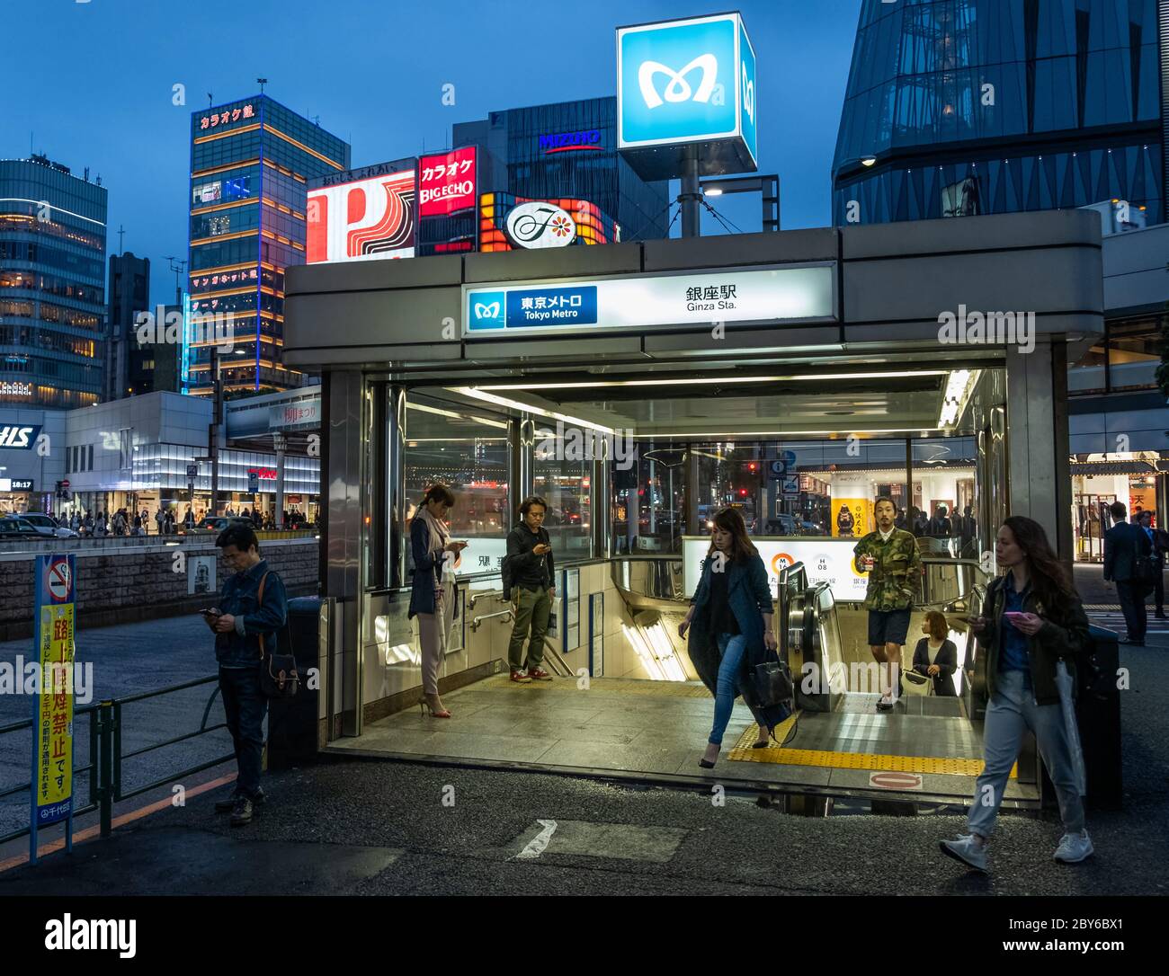 Fußgänger an der Tokyo Metro Ginza Station U-Bahn Eingang in der Nacht. Stockfoto