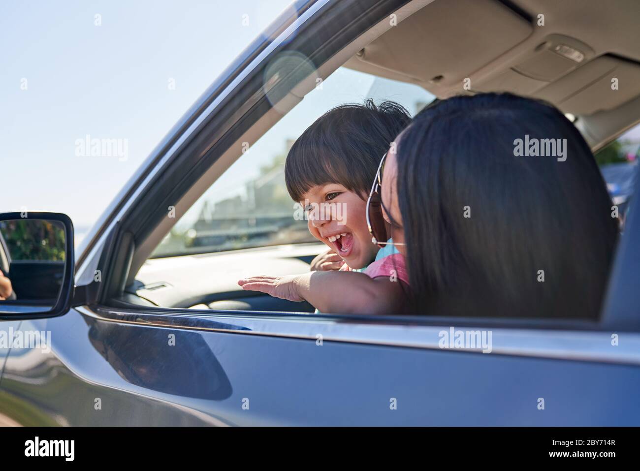 Glückliche Mutter und Sohn im sonnigen Auto Stockfoto