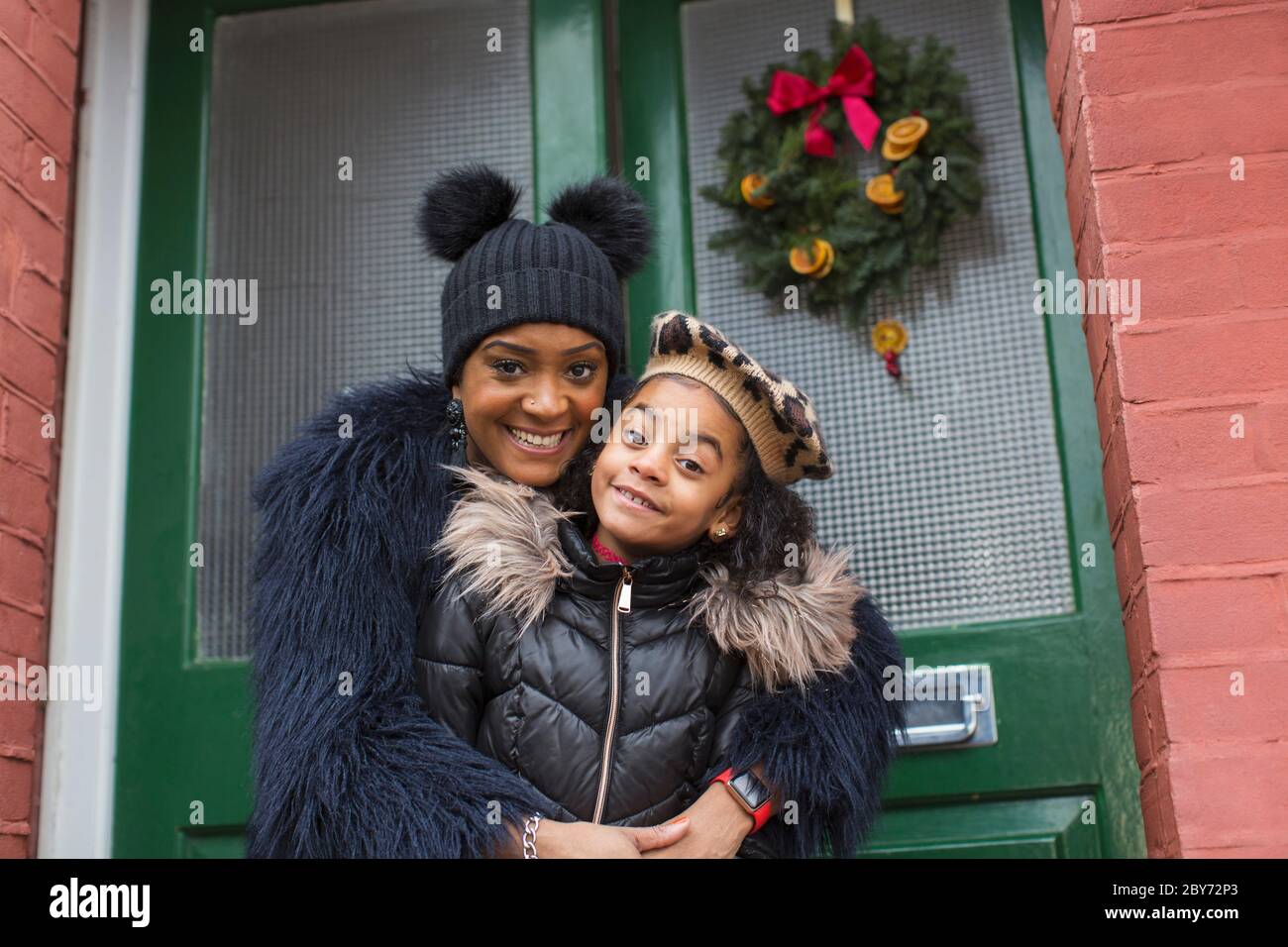 Portrait glückliche Mutter und Tochter umarmt auf der Vorderseite stoop Stockfoto