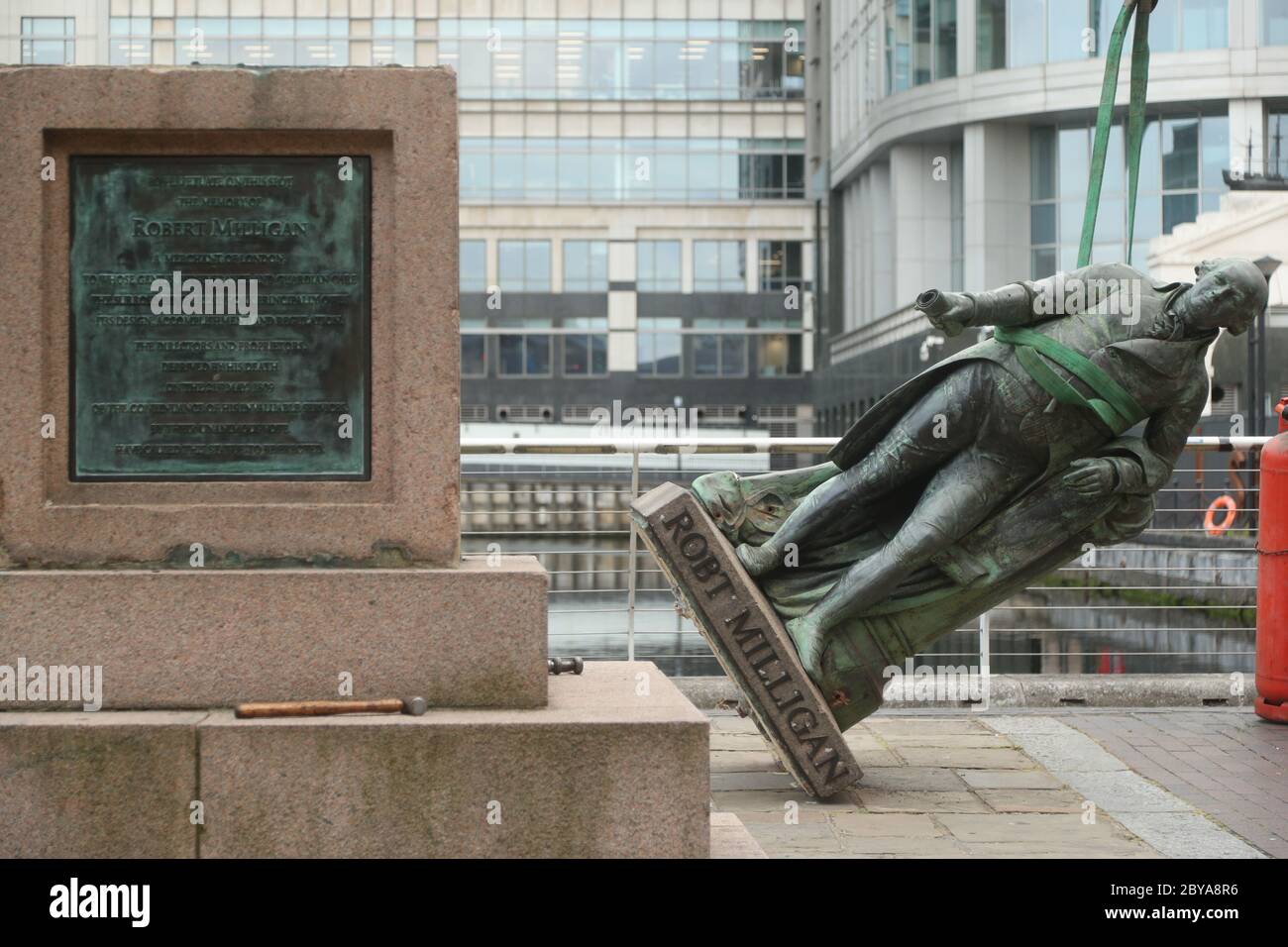 Arbeiter bereiten sich darauf vor, eine Statue des Sklavenbesitzers Robert Milligan am West India Quay, East London, abzubauen, während die Labour Councils in ganz England und Wales beginnen, Denkmäler und Statuen in ihren Städten zu überprüfen. Nach einem Protest wurden in Bristol die Statue eines Sklavenhändlers von Anti-Rassismus-Aktivisten niedergerissen. Stockfoto