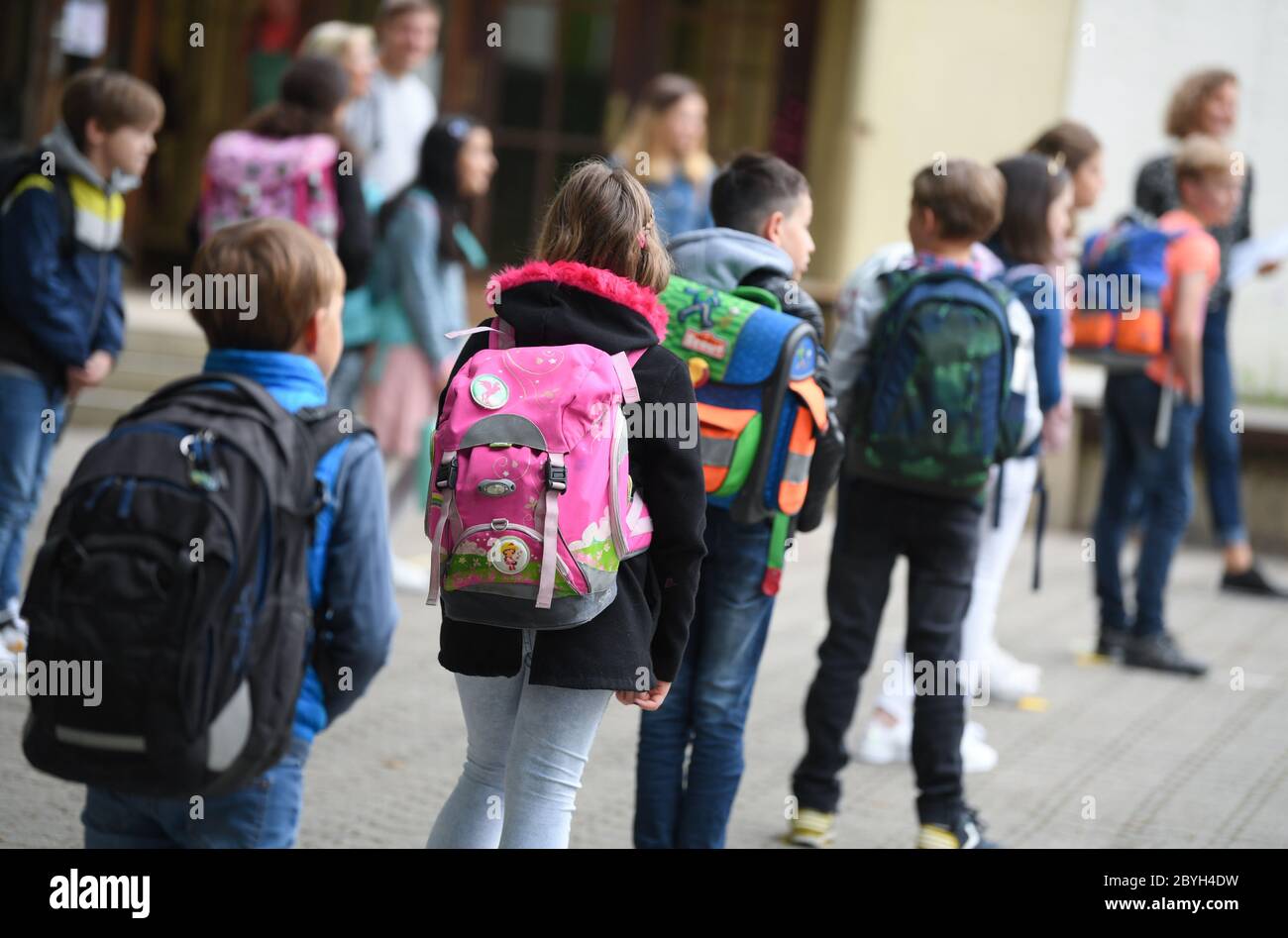 10. Juni 2020, Hessen, Wiesbaden: Schüler der vierten Klasse der Robert Schumann Grundschule stehen auf dem Schulhof in der Ferne. Am 22. Juni starten die Hessischen Grundschulen wieder mit gemeinsamen Präsenzkursen für alle Kinder. Die Distanzregel gilt dann nicht mehr. Foto: Arne Dedert/dpa Stockfoto