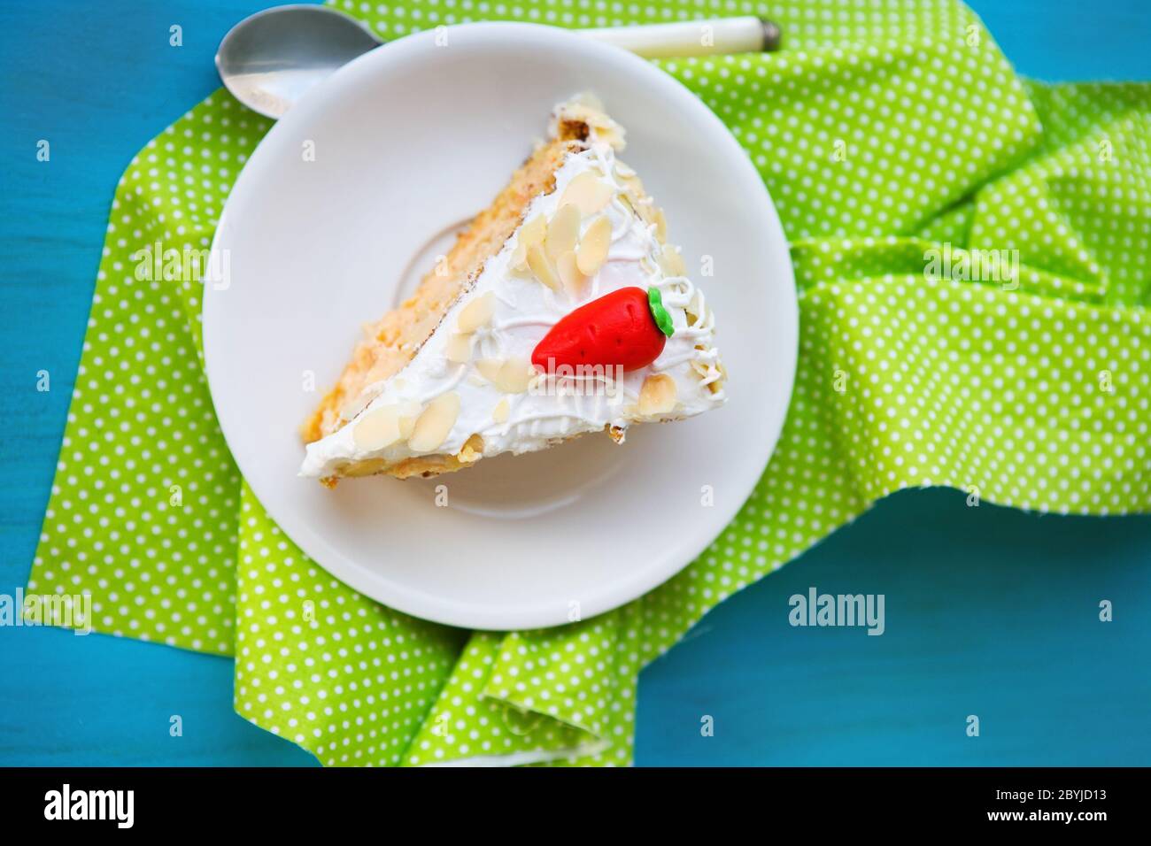 Stück Karottenkuchen mit Glasur und kleine Karotte Stockfoto