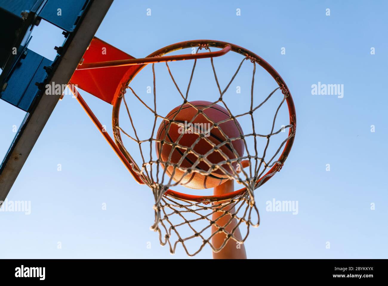 Street Basketball Slam Dunk Wettbewerb. Nahaufnahme des Balls, der in den Reifen fällt. Urban Jugend Spiel. Konzept des Erfolgs, Punkte sammeln und gewinnen Stockfoto