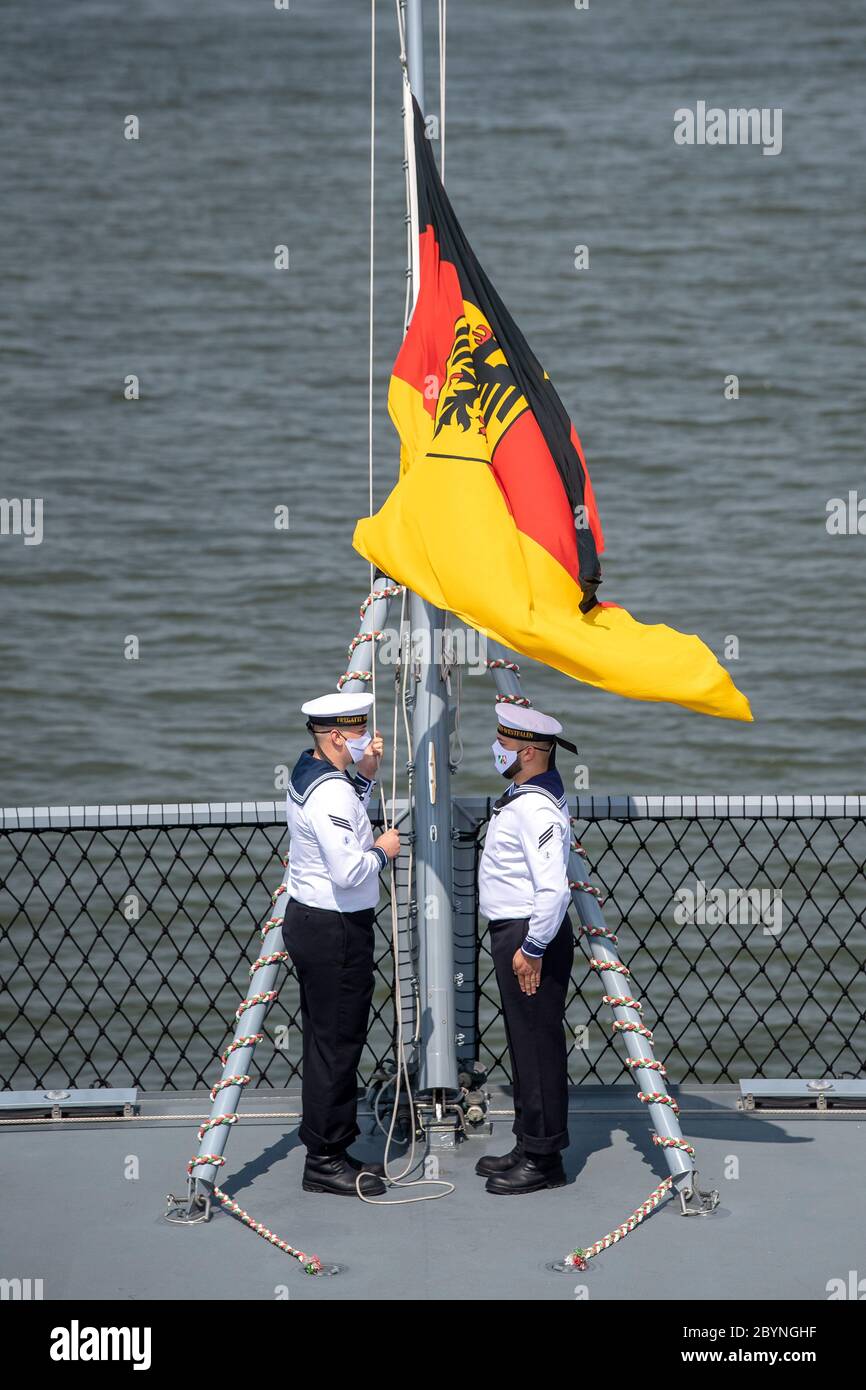 Wilhelmshaven, Deutschland. Juni 2020. Marineinfanteristen heben die Flagge auf der Fregatte Nordrhein-Westfalen. Die Marine hat die zweite von vier neuen Fregatten der F 125 Klasse in Dienst gestellt. Die Nordrhein-Westfalen sind das Schwesterschiff der Baden-Württemberg, die vor einem Jahr in die Flotte aufgenommen wurde. Das Schiff wurde für langfristige maritime Stabilisierungsoperationen gebaut. Quelle: Sina Schuldt/dpa Pool/dpa/Alamy Live News Stockfoto