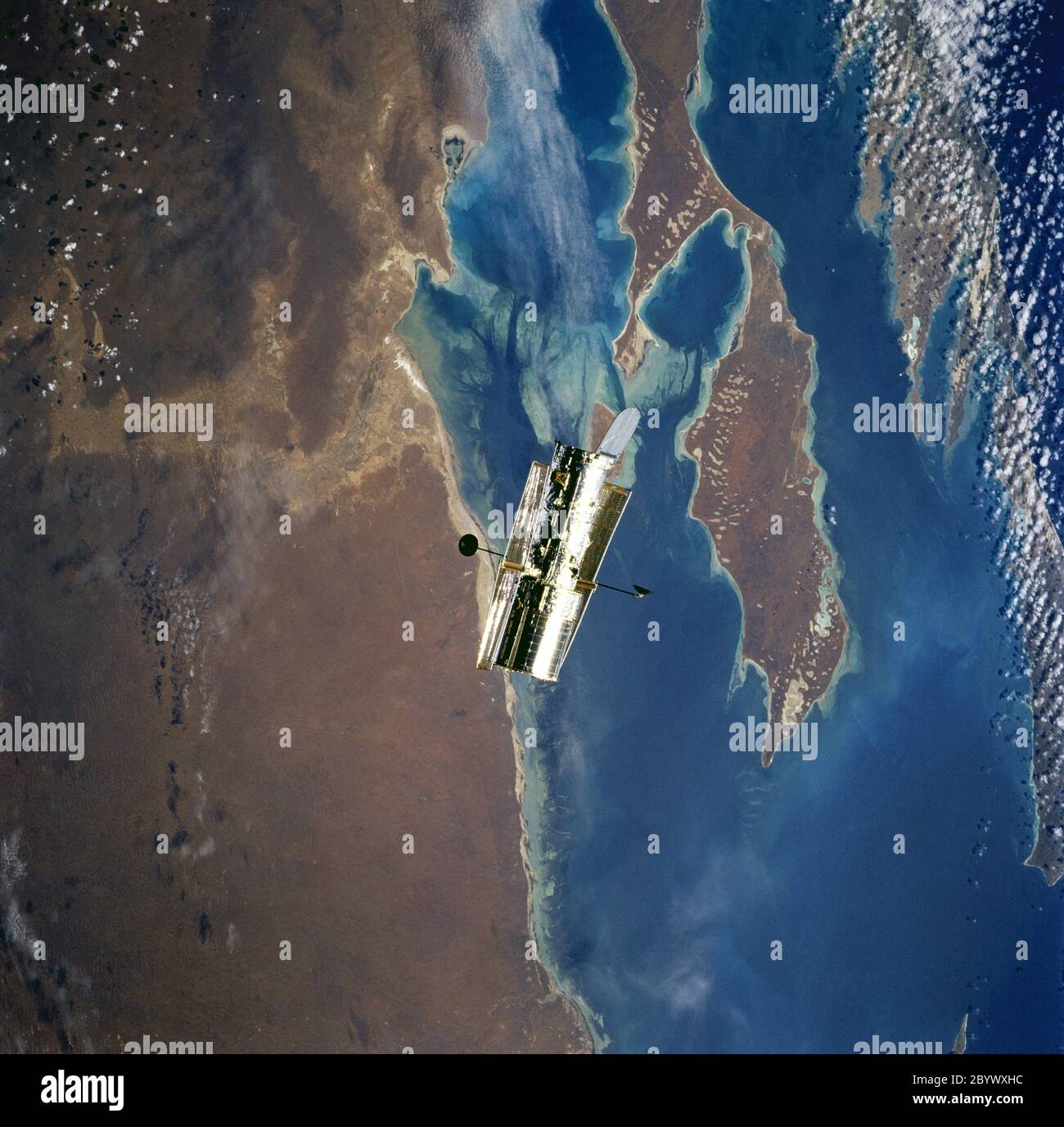 STS082-746-071 (11-21. Feb. 1997) --- Diese fast vertikale Ansicht, fotografiert von der Space Shuttle Discovery, zeigt das Hubble Space Telescope (HST) über der Shark Bay. Die flachsten Teile der Bucht erscheinen hellblau. In dieser Ansicht des trockenen Westens Australiens sind auf der Peron Peninsula (unteres Zentrum) von Südwesten nach Nordosten (von links unten nach rechts oben) Sanddünen deutlich sichtbar, die vom vorherrschenden Wind geblasen werden. Hartog Island liegt unten rechts. Stockfoto