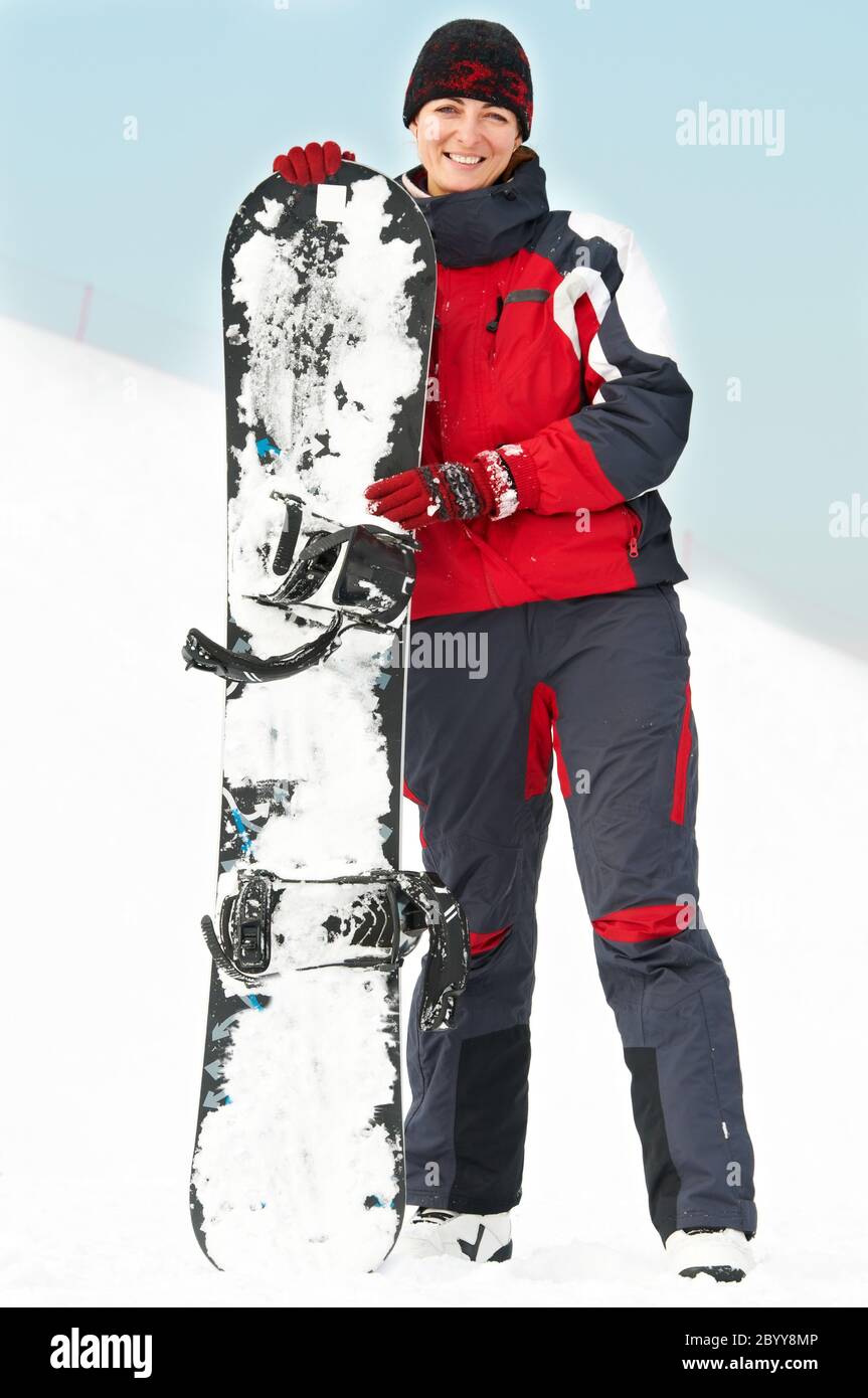 Glückliche Frau mit Snowboard Stockfoto