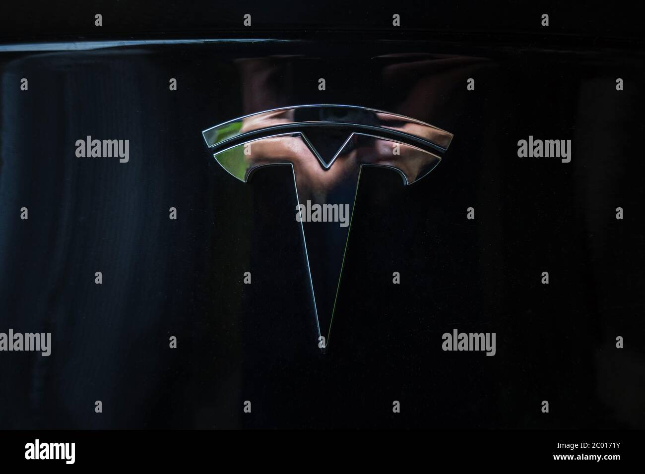 Prag, Tschechische Republik - Juni 2020: Tesla Motoren Auto Abzeichen Logo dunklen Hintergrund. Moderner Elektrofahrzeughersteller. Stockfoto