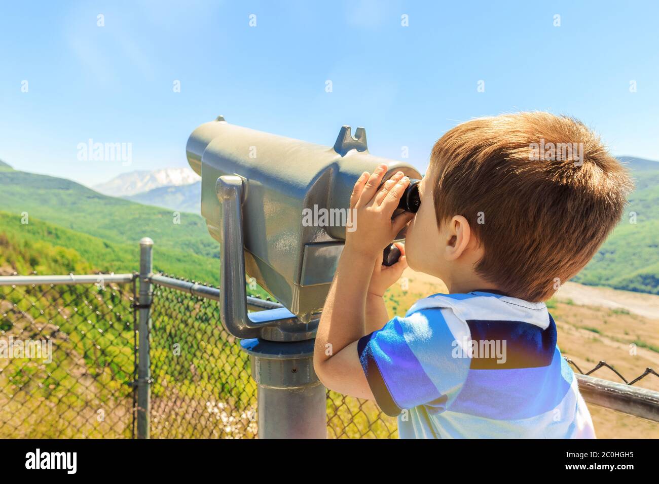 Kleiner Junge mit Teleskop Mount St. Helens Peak vom Aussichtspunkt, Washington State, USA zu sehen Stockfoto