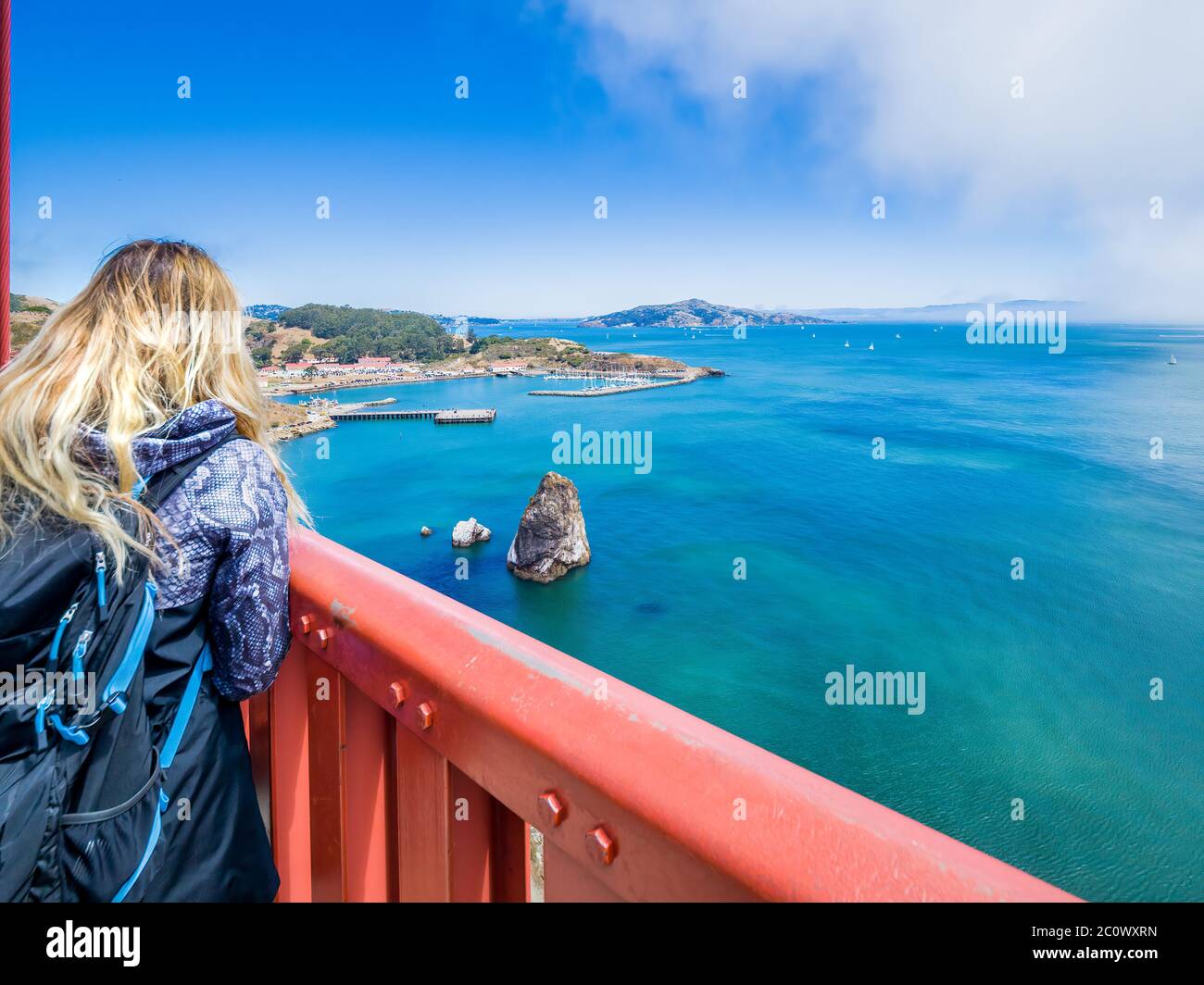 Blonde Mädchen bewundert Panorama von Golden Gate Bridge Bay, San Francisco, in sonnigen Tag. Kalifornien USA. Eine Ikone von San Francisco, eine von Bedeutung für Stockfoto