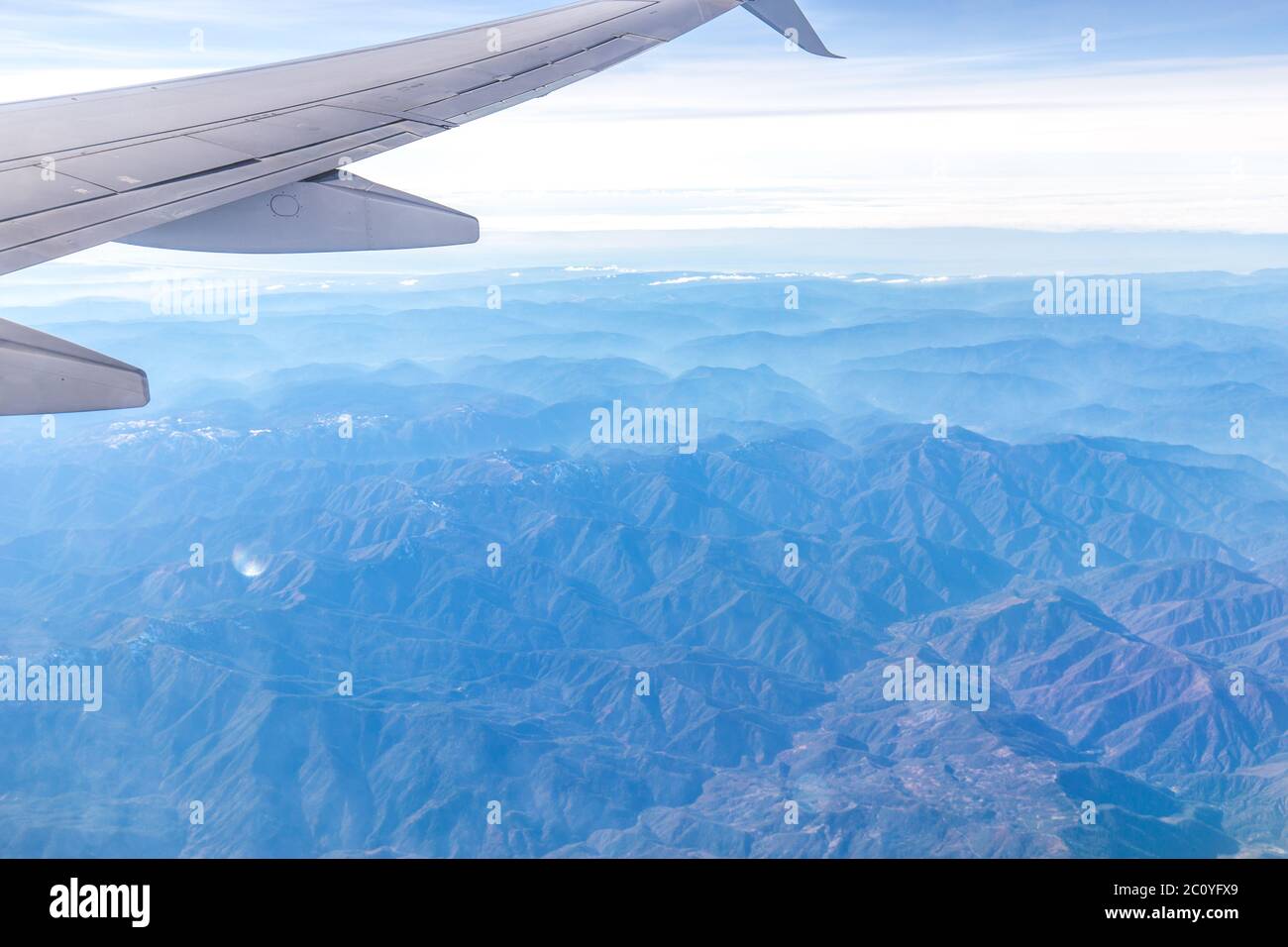 Landschaft der Berge durch die Fenster des Flugzeugs Stockfoto