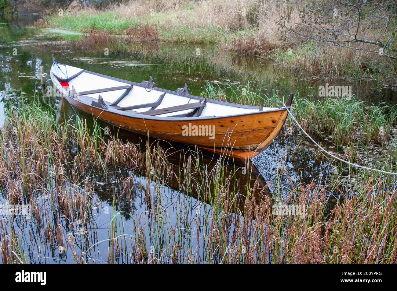 Altes Holzboot auf einem ruhigen See Stockfoto