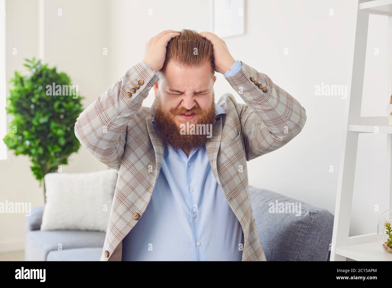 Stress Depression Neurose Unhappiness müde Panik Kopfschmerzen Konzept. Ein Mann hält seinen Kopf mit den Händen Stockfoto