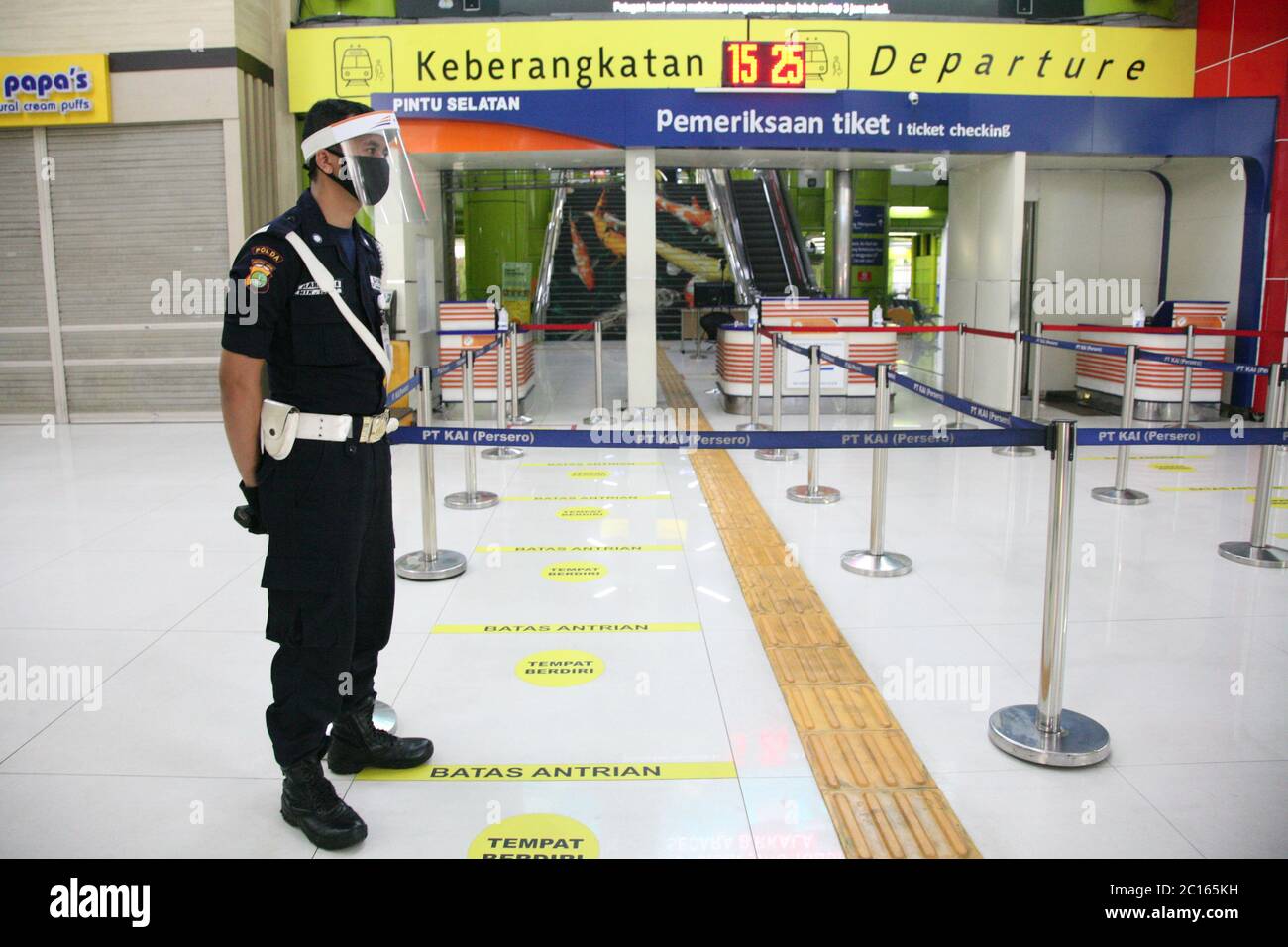 Jakarta, Indonesien. Juni 2020. Offizier mit Gesichtsmaske, der den Eingang der Passagiere in der Gambir Station im Zentrum von Jakarta bewacht. PT Kereta API Indonesia (Persero) nahm den Betrieb von regelmäßigen Fernzügen auf, die nach der Einführung des COVID-19-Präventionsprotokolls ab Juni 12 wieder in Betrieb genommen wurden. Früher wurden regelmäßige Fernzüge durch außerordentliche Eisenbahnen ersetzt, da die Beförderung von Personen eingeschränkt und die Bewegung eingeschränkt war. (Foto von Kuncoro Widyo Rumpoko/Pacific Press) Quelle: Pacific Press Agency/Alamy Live News Stockfoto