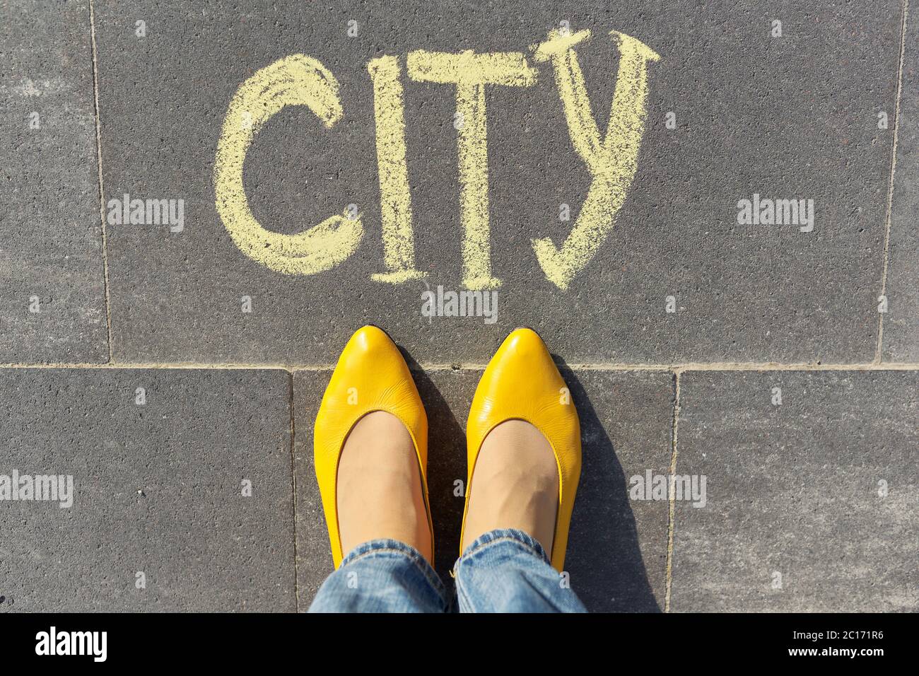 Stadtkonzept, Draufsicht auf Frauenbeine und Text in Kreide auf grauem Bürgersteig geschrieben Stockfoto