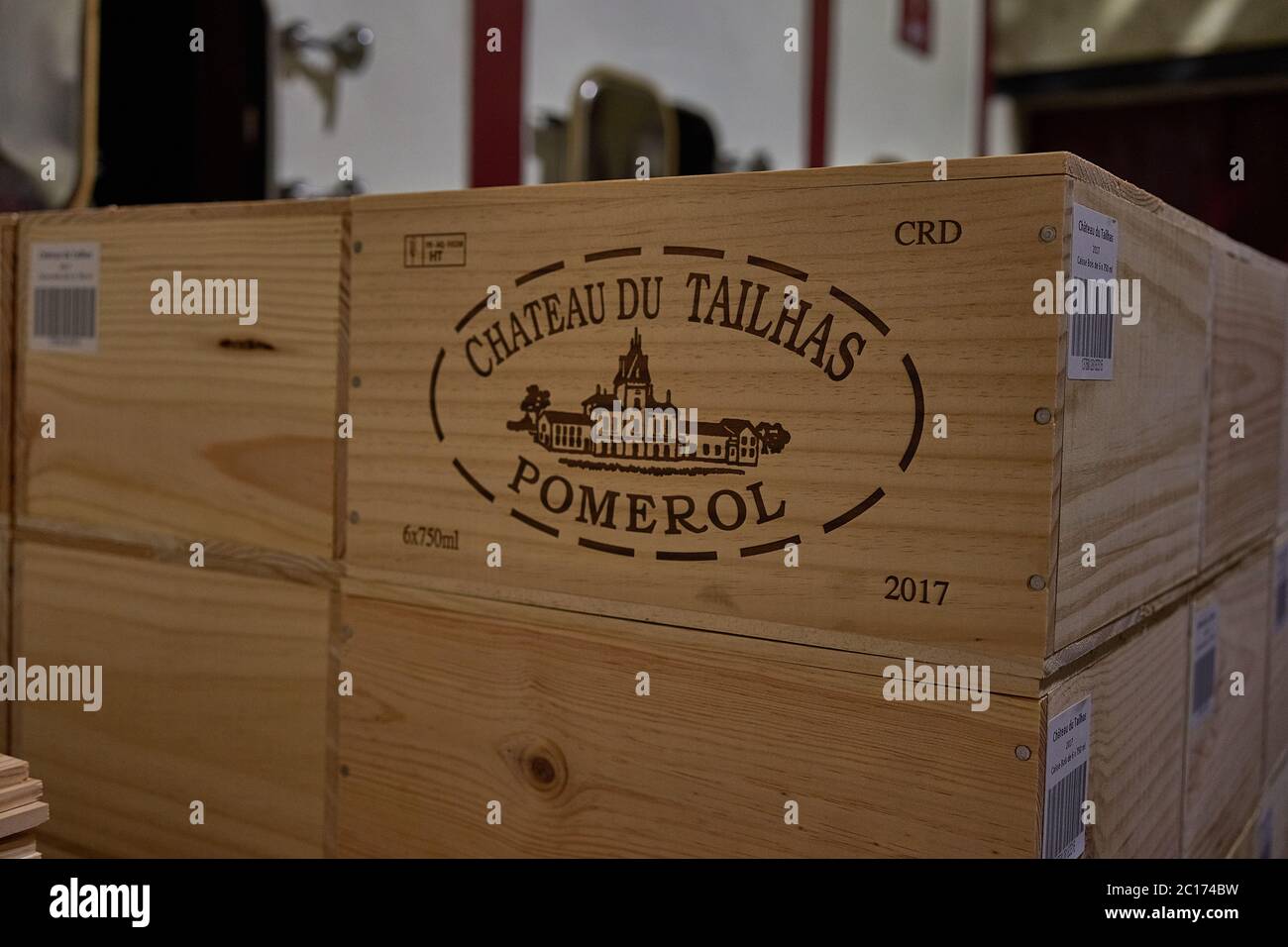 Holzkiste von Chateau du Tailhas Pomerol 2017 mit dem ovalen Gutssiegel bedruckt, gestapelt im Keller, Pomerol, Bordeaux, Frankreich Stockfoto