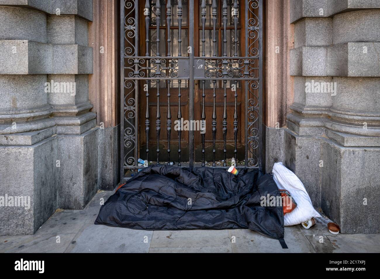Bettwäsche und persönliche Gegenstände eines rauen Schlafenden, die tagsüber in Whitehall, London, gesehen wurden Stockfoto