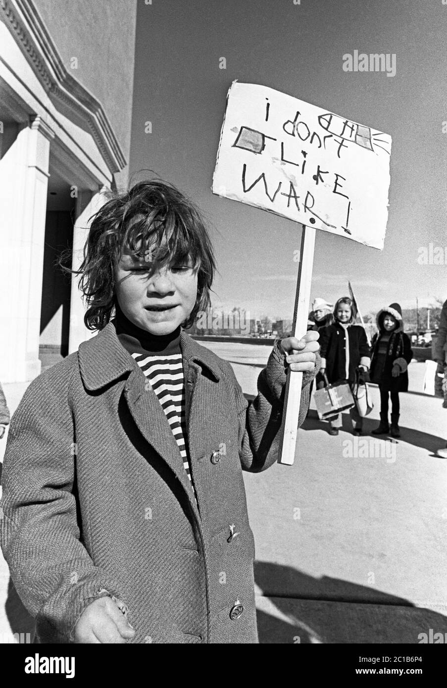 Porträt eines jungen Mannes mit einem Schild gegen den Vietnamkrieg, um 1973, Santa Fe, New Mexico, Gelände des Staatskapitolgebäudes. Stockfoto