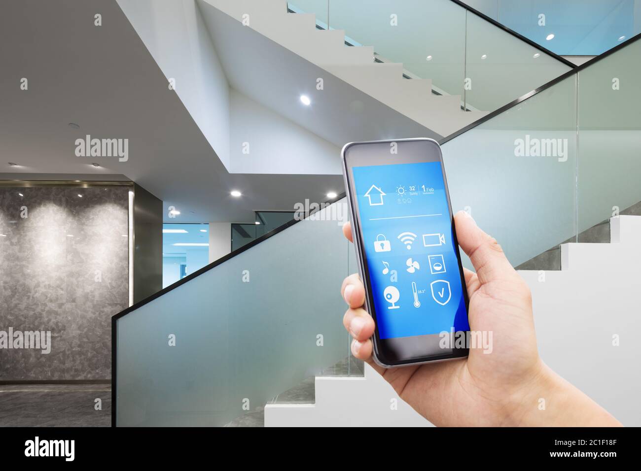 Mobiles Telefon mit Smart Home im modernen Büro Stockfoto
