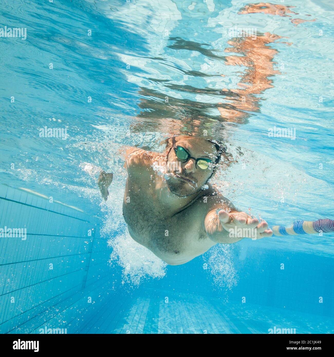 Männliche Schwimmer im Pool. Unterwasser Foto mit kopieren. Stockfoto