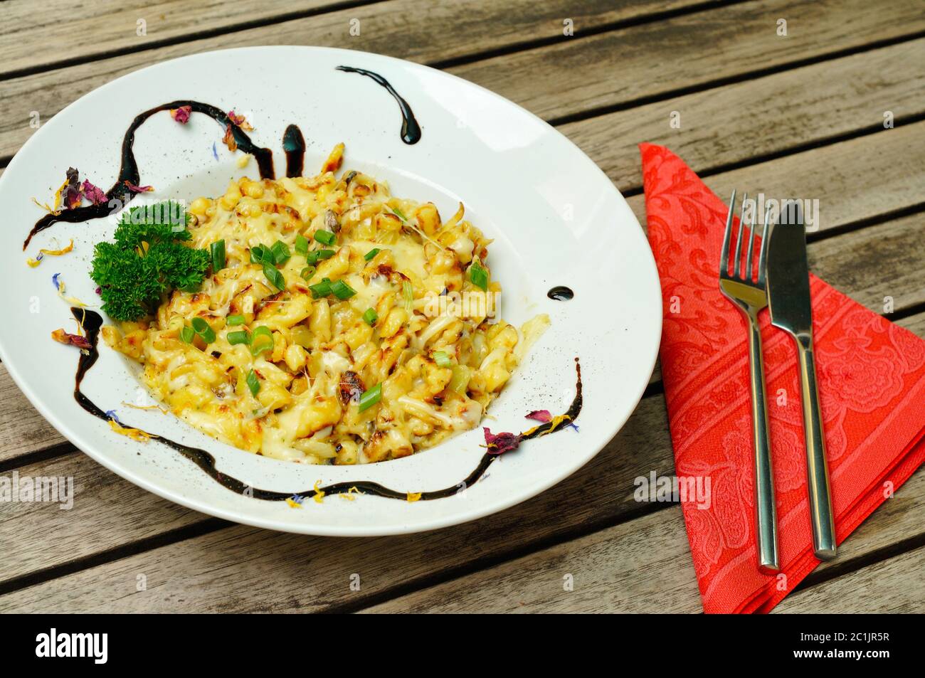 Käse spätzle auf einem Teller mit einem Salat. Stockfoto