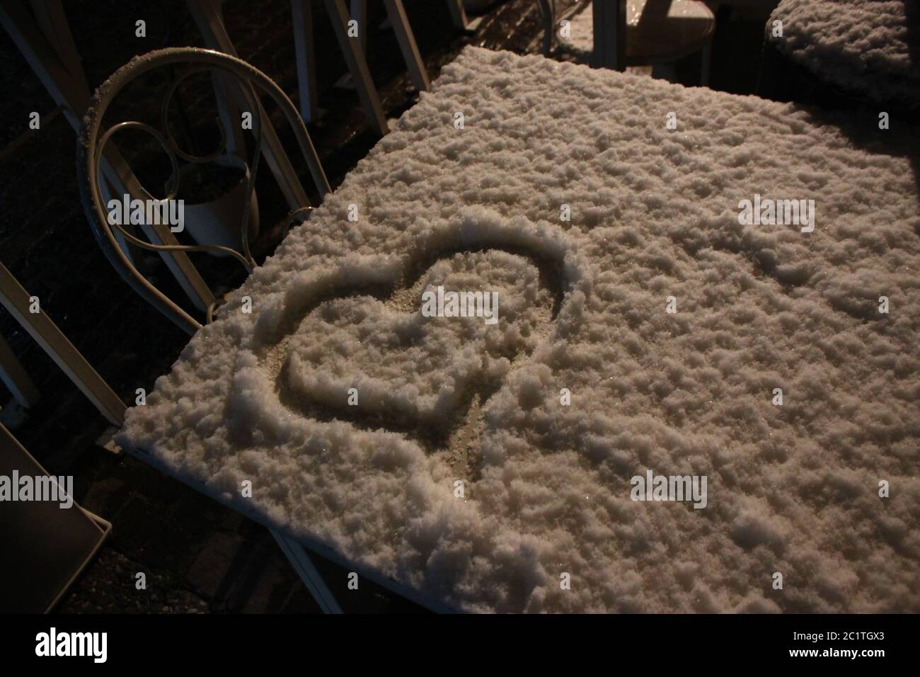 Ein Herz auf einem mit Schnee bedeckten Tisch gemalt Stockfoto