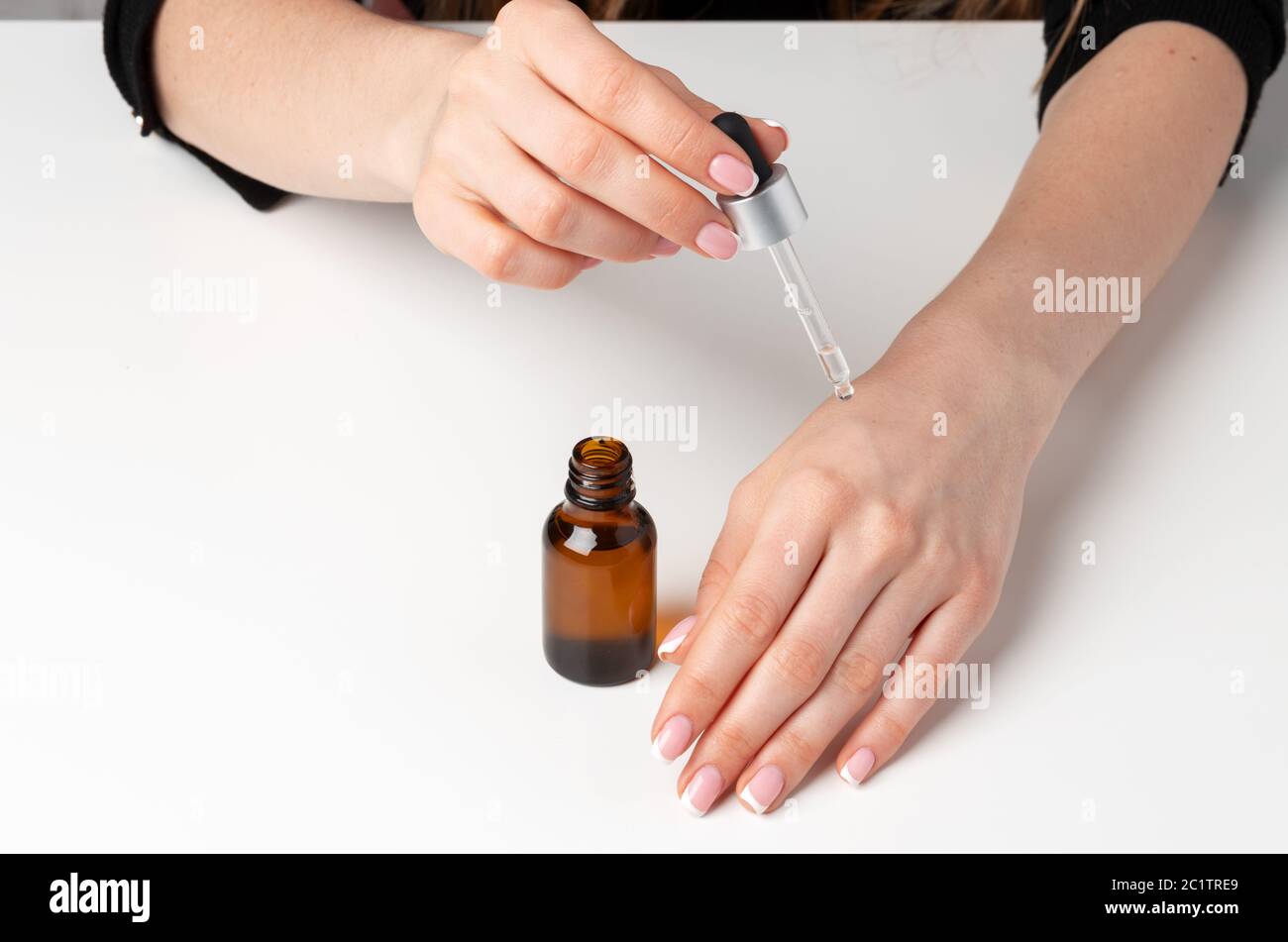 Weibliche Hand Anwendung Hautpflege Produkt mit Pipette Stockfoto