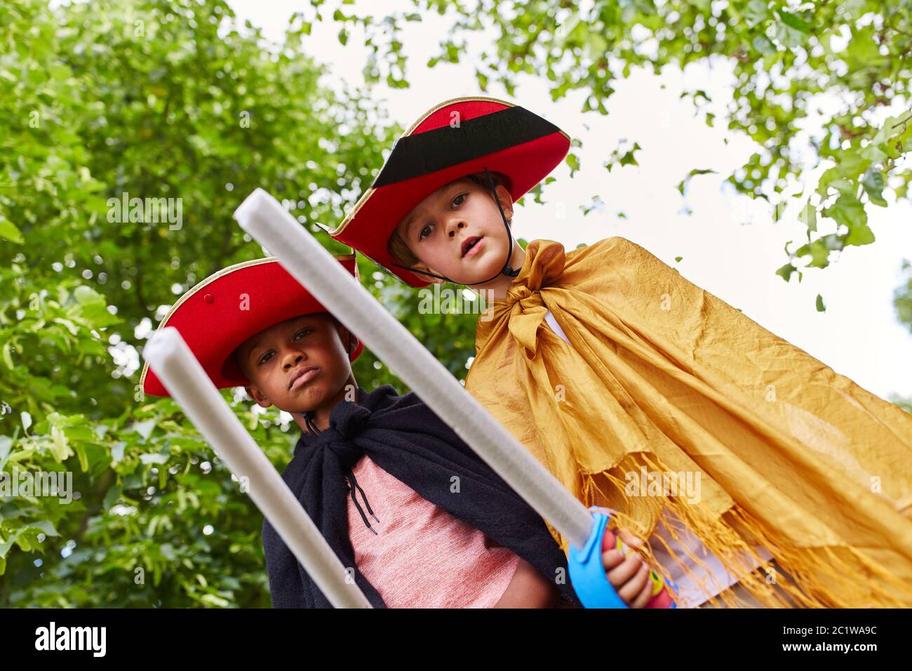 Zwei Kinder an Fasching mit Kostüm als Piraten mit Schwertern Stockfoto
