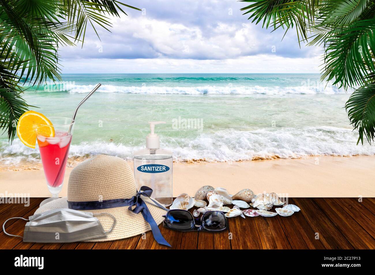 Urlaub in der Neuen Normalität nach COVID-19 Coronavirus Pandemie. Tourismus-Konzept zeigt Strand mit Hand Desinfektionsmittel, medizinische Gesichtsmaske zwischen Strand ha Stockfoto