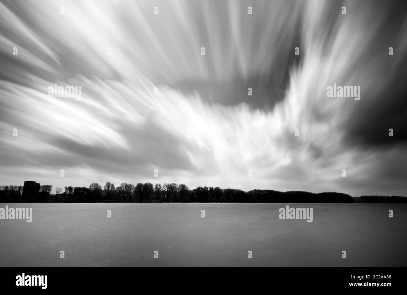 Langzeitbelichtung schwarz-weiße Landschaft an der Sloterplas in Amsterdam, Niederlande, mit Wolken vorbei Stockfoto