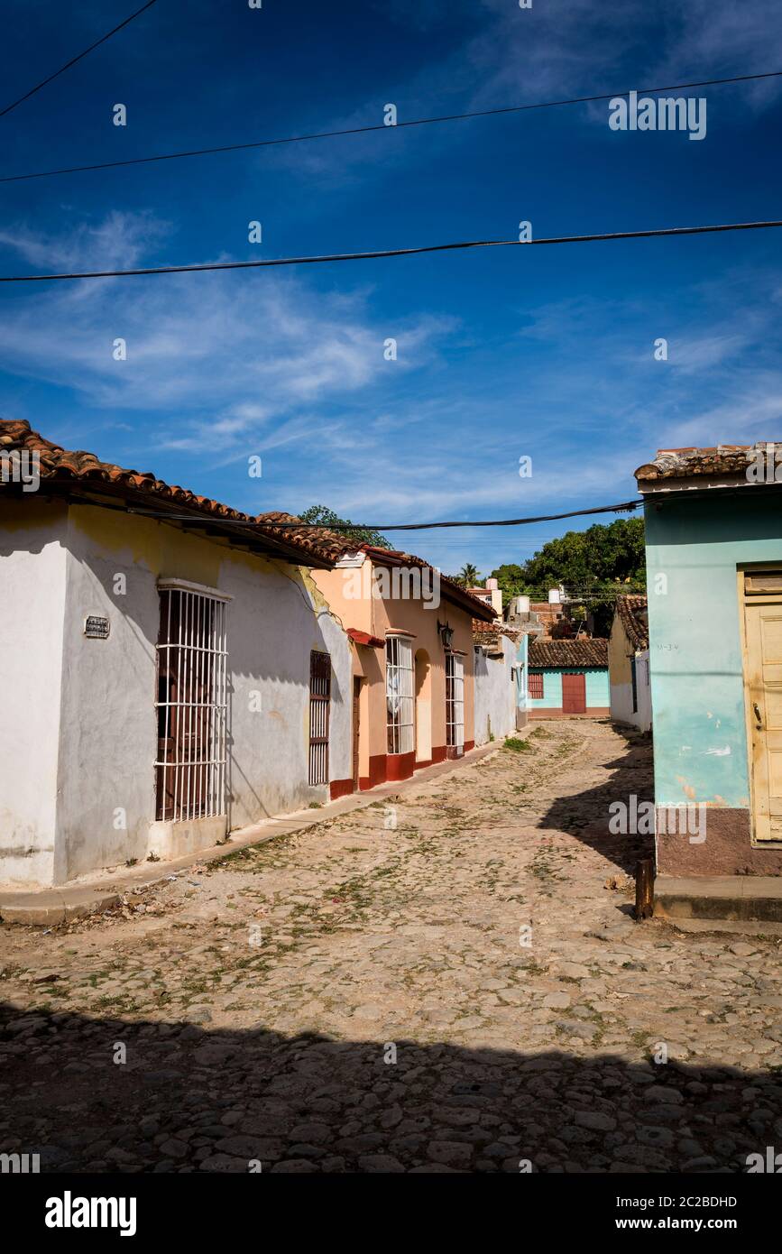 Leere Kopfsteinpflasterstraße und malerische spanische Kolonialarchitektur in der Wohngegend des Stadtzentrums, Trinidad, Kuba Stockfoto