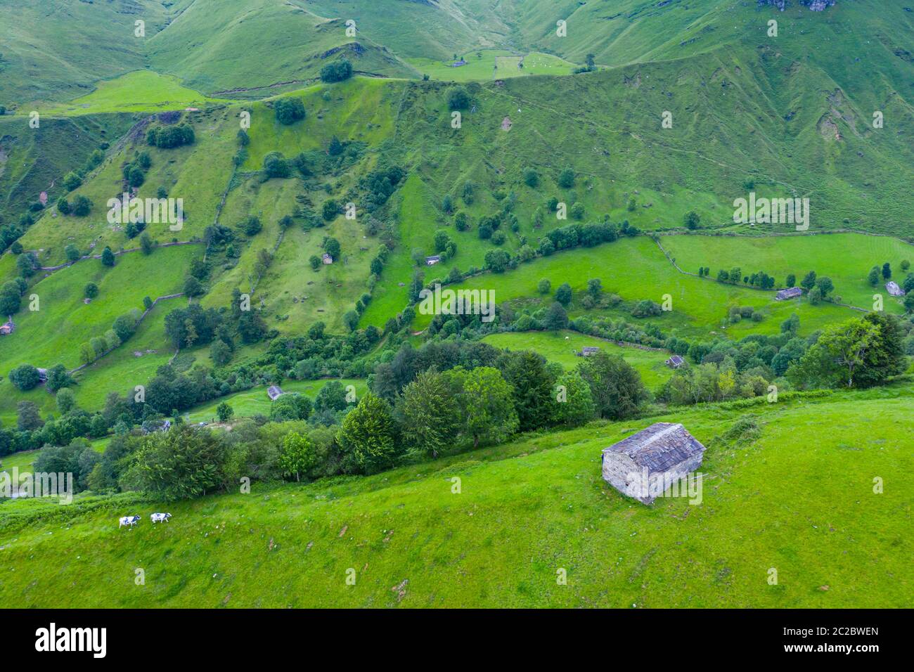 Luftaufnahme mit einer Drohne von der Frühlingslandschaft von paliegas Hütten und Wiesen im Miera Tal in der Autonomen Gemeinschaft Kantabrien. Spanien, Europa Stockfoto